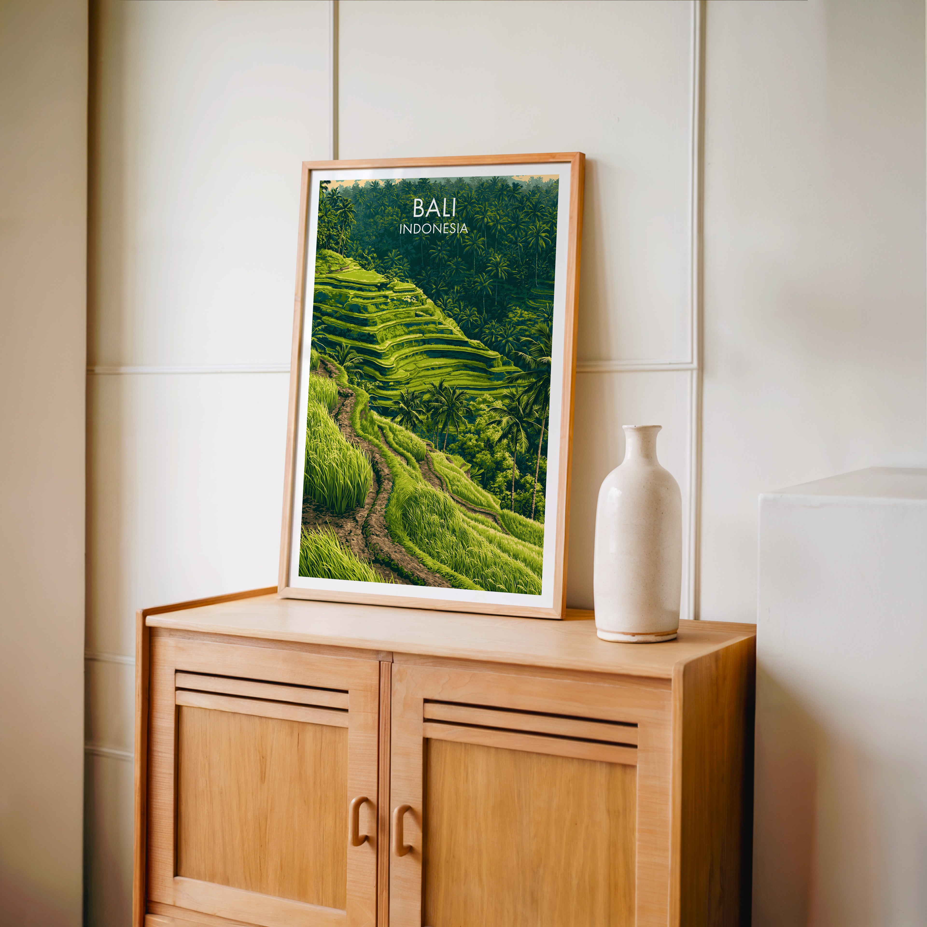 Small Ubud Rice Terraces Bali travel poster in an oak frame on a mid-century sideboard with a ceramic vase
