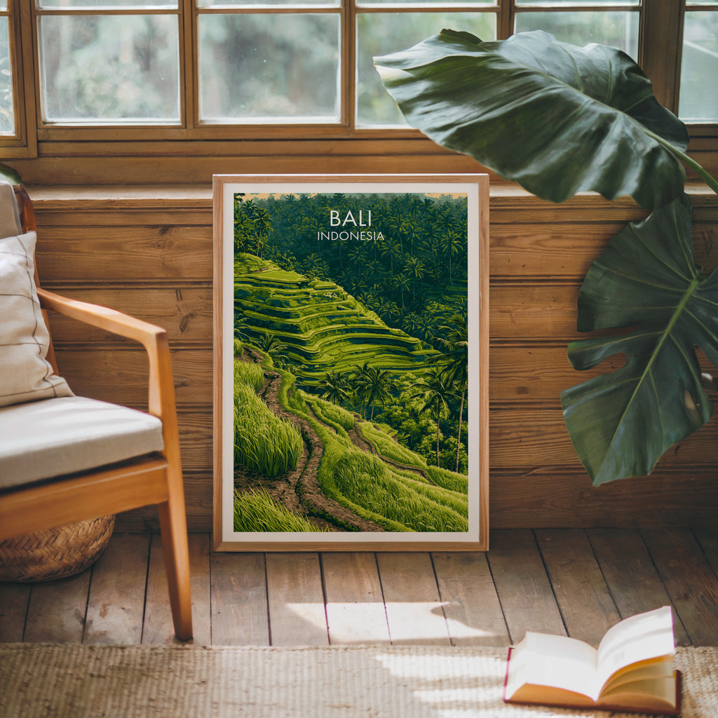 Framed Ubud Rice Terraces Bali poster leaning against a timber cabin wall with monstera leaves and an open book