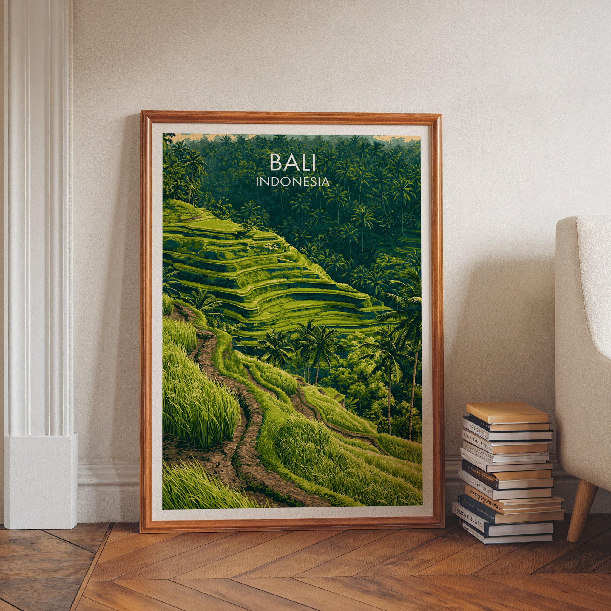 Ubud Rice Terraces Bali art print in a walnut frame leaning in a hallway beside stacked books