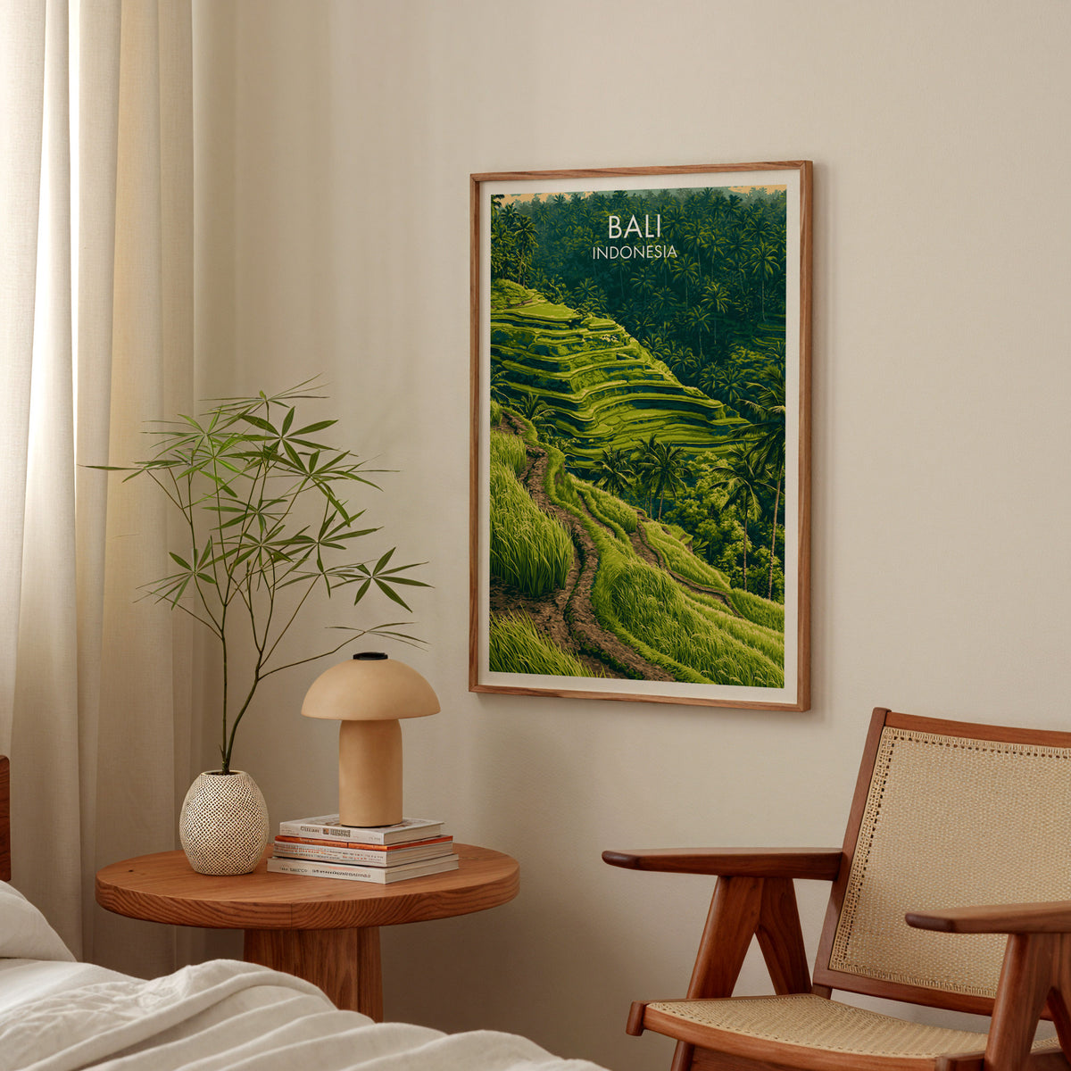 Ubud rice terraces Bali poster in an oak frame above a round bedside table with a mushroom lamp and bamboo stems