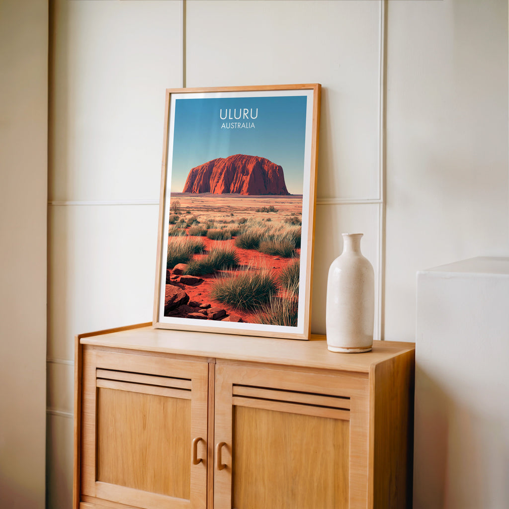 Outback travel print in an oak frame on a light oak cabinet by a cream panelled wall