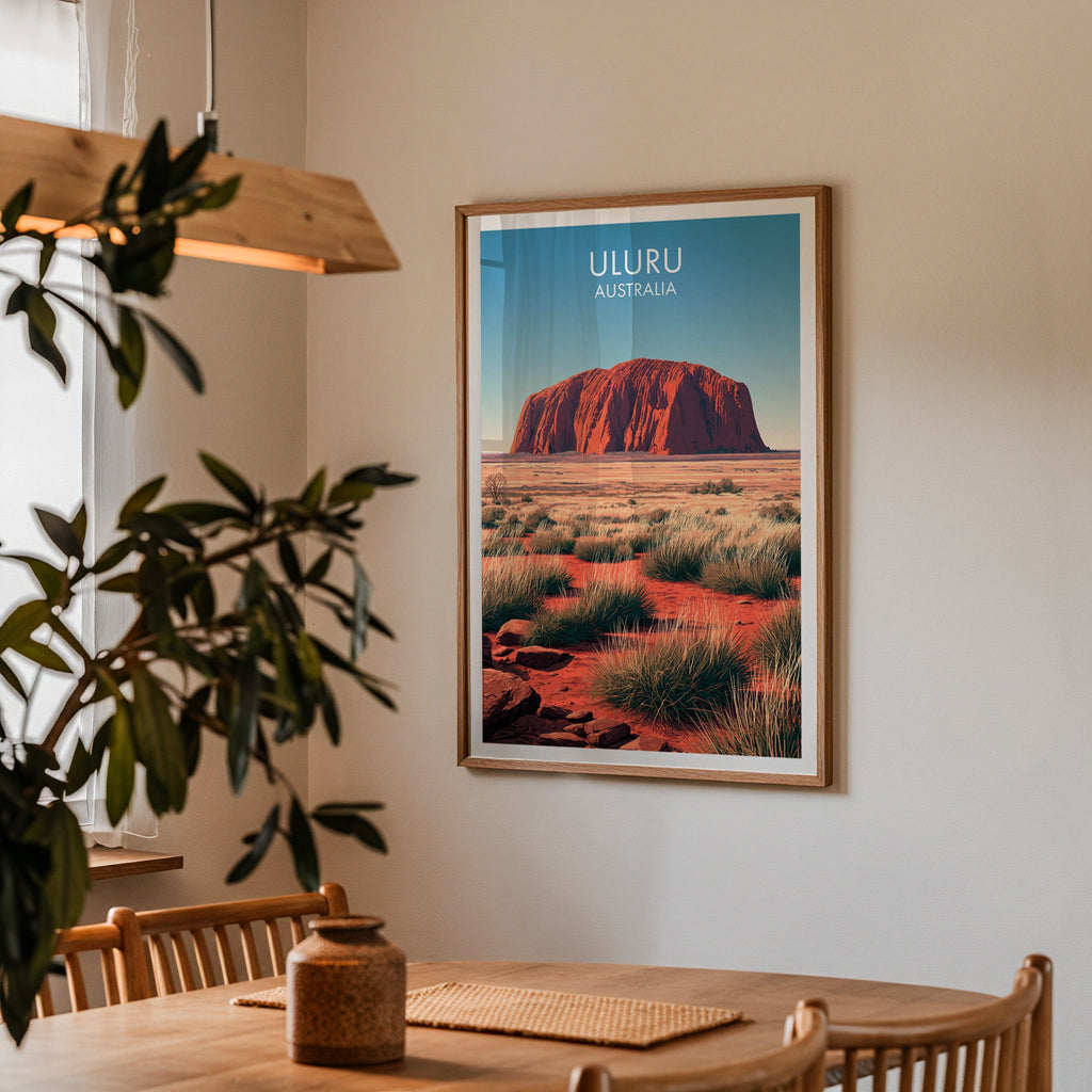 Desert plain wall art in a dining corner above an oak table with spindle chairs and a pendant light