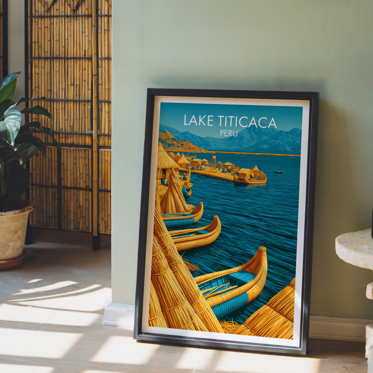 Uros village print in a dark brown frame on a sage green wall with a bamboo screen and terracotta plant