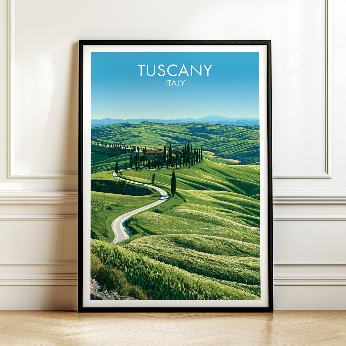 Val d'Orcia cypress road print, black frame leaning on a white panelled wall above a herringbone floor