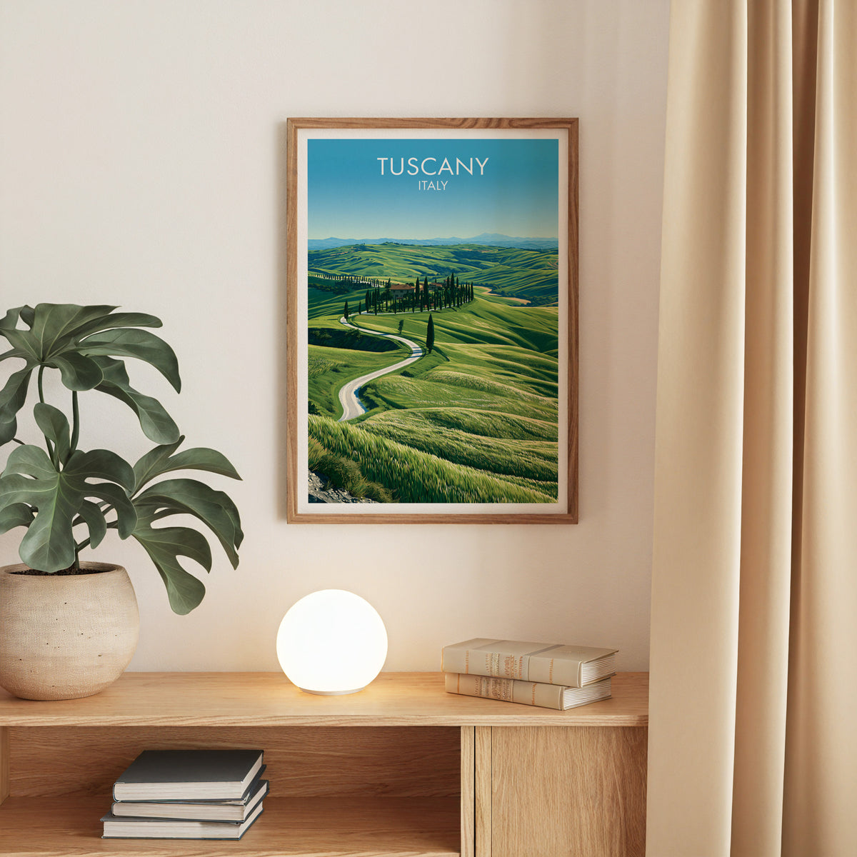 Val d'Orcia cypress road print, oak frame above an oak console with a monstera and a round globe lamp