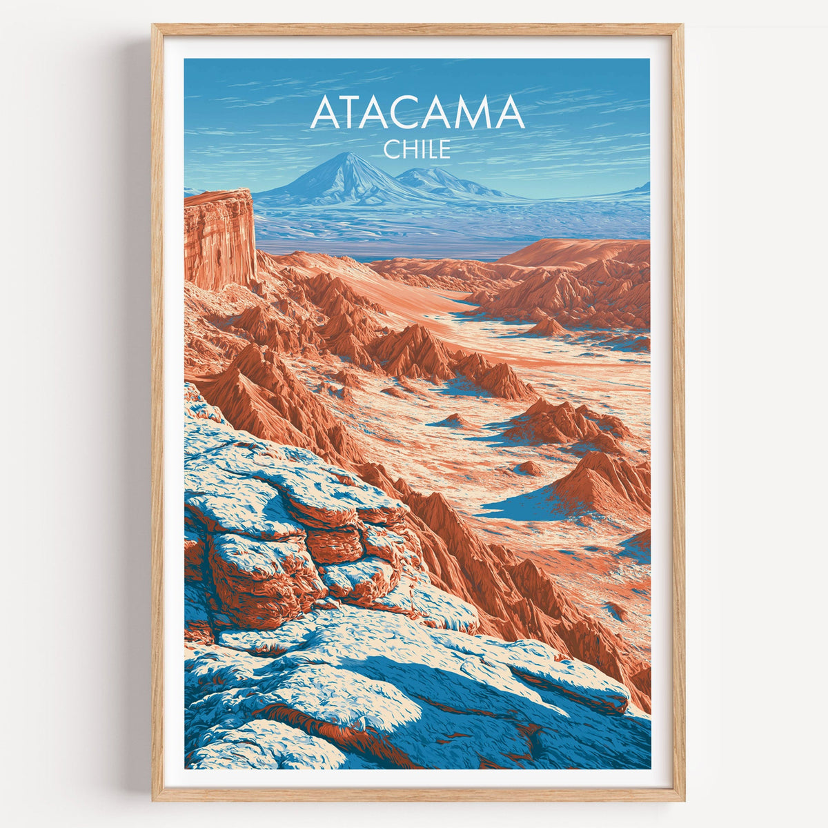 Valle de la Luna Atacama travel poster of copper desert ridges in a light oak frame on a plain white wall