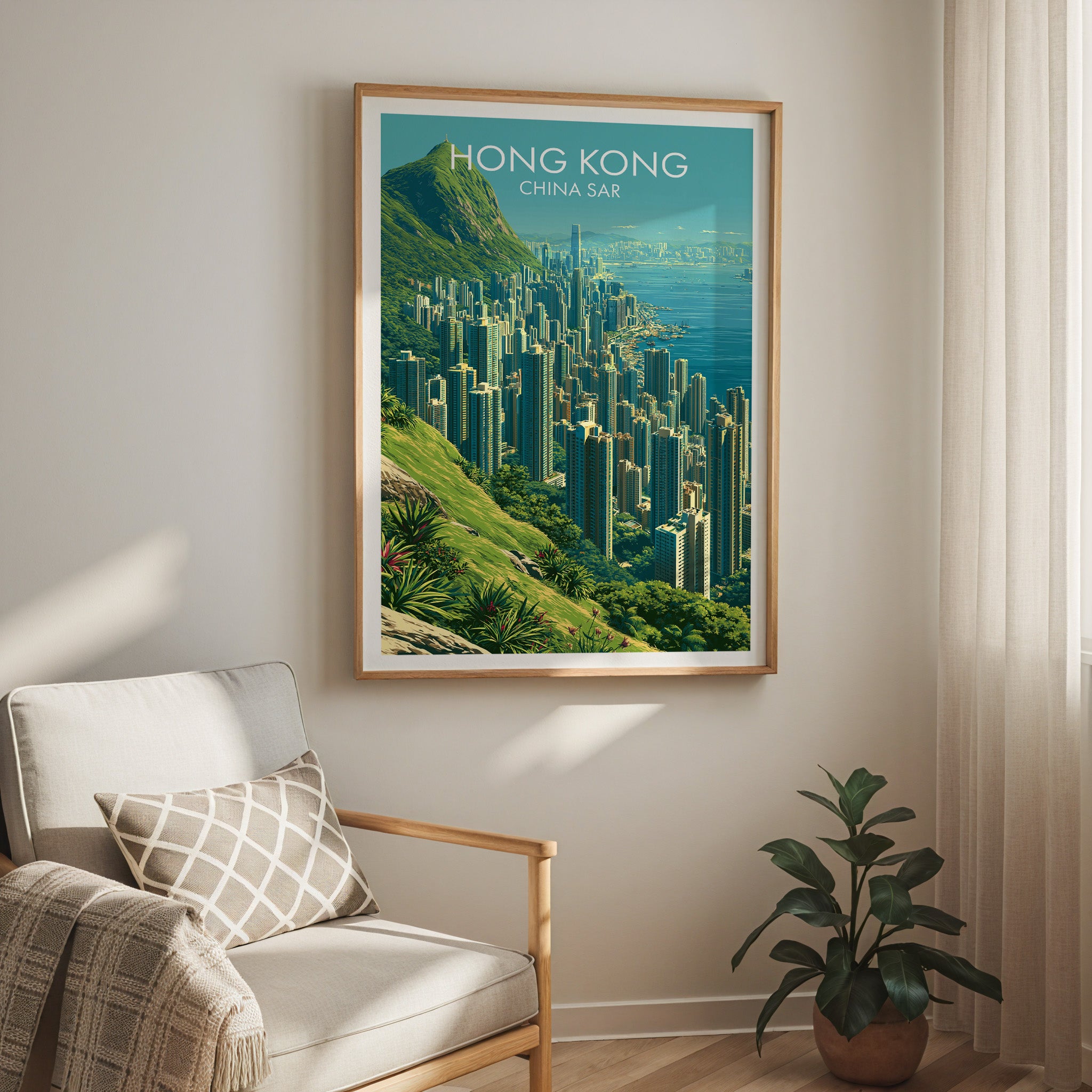 Victoria Peak Hong Kong travel print in a light oak frame on a living room wall beside a linen armchair