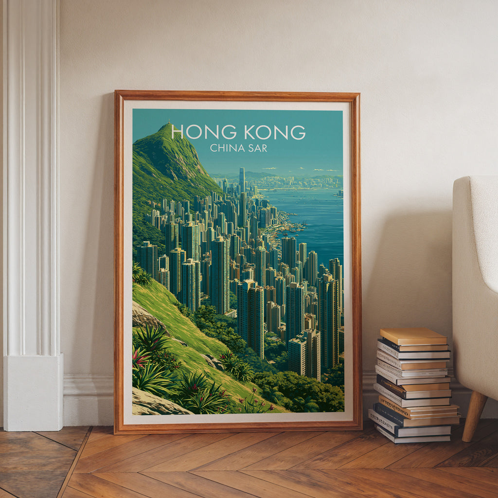 Victoria Peak Hong Kong art print in a walnut frame leaning in a hallway beside stacked books