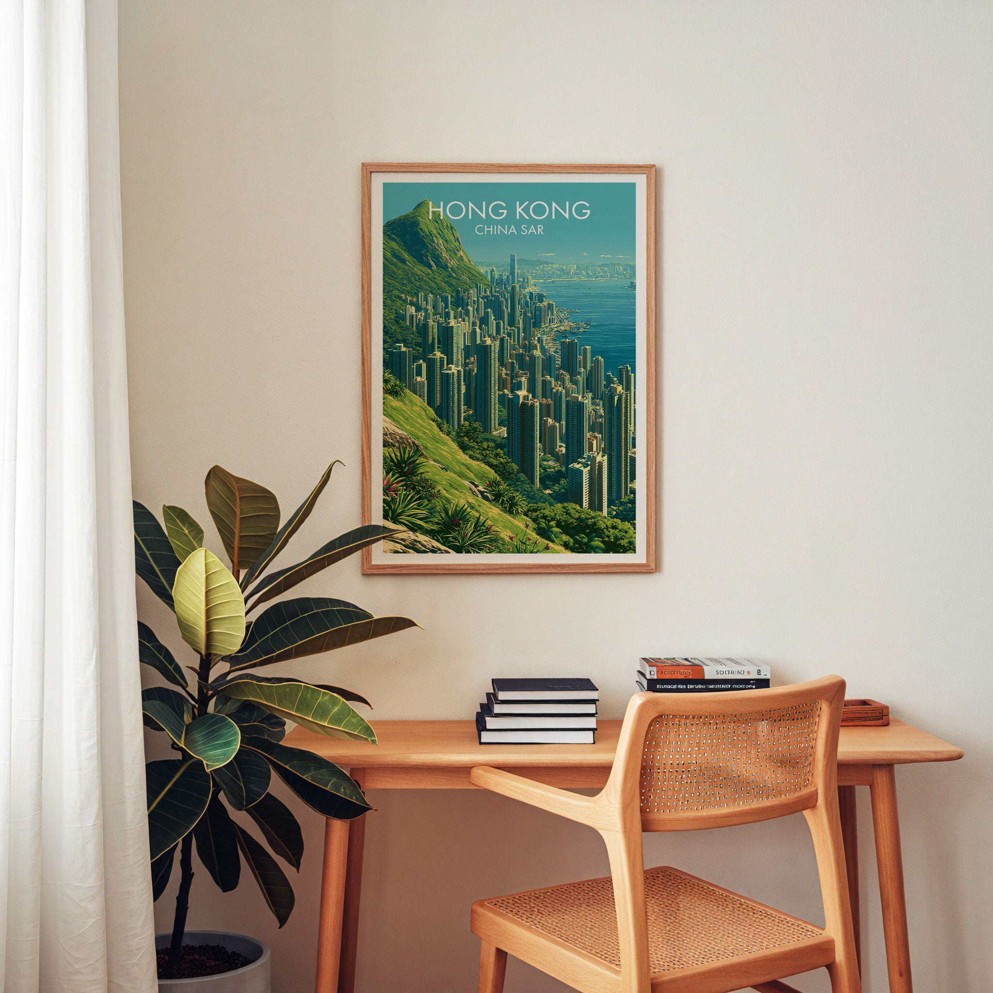 Victoria Peak Hong Kong wall art above a wooden home office desk with a rattan chair and books