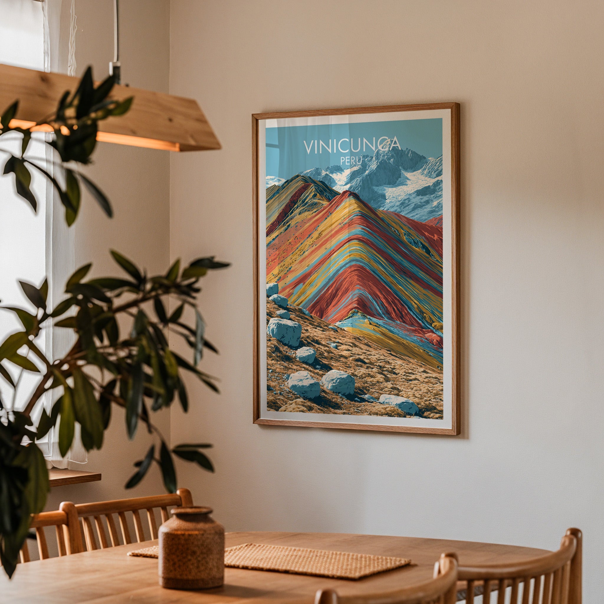 Peru hiking print in an oak frame in a dining corner with a wood table, cane chairs and wood pendant