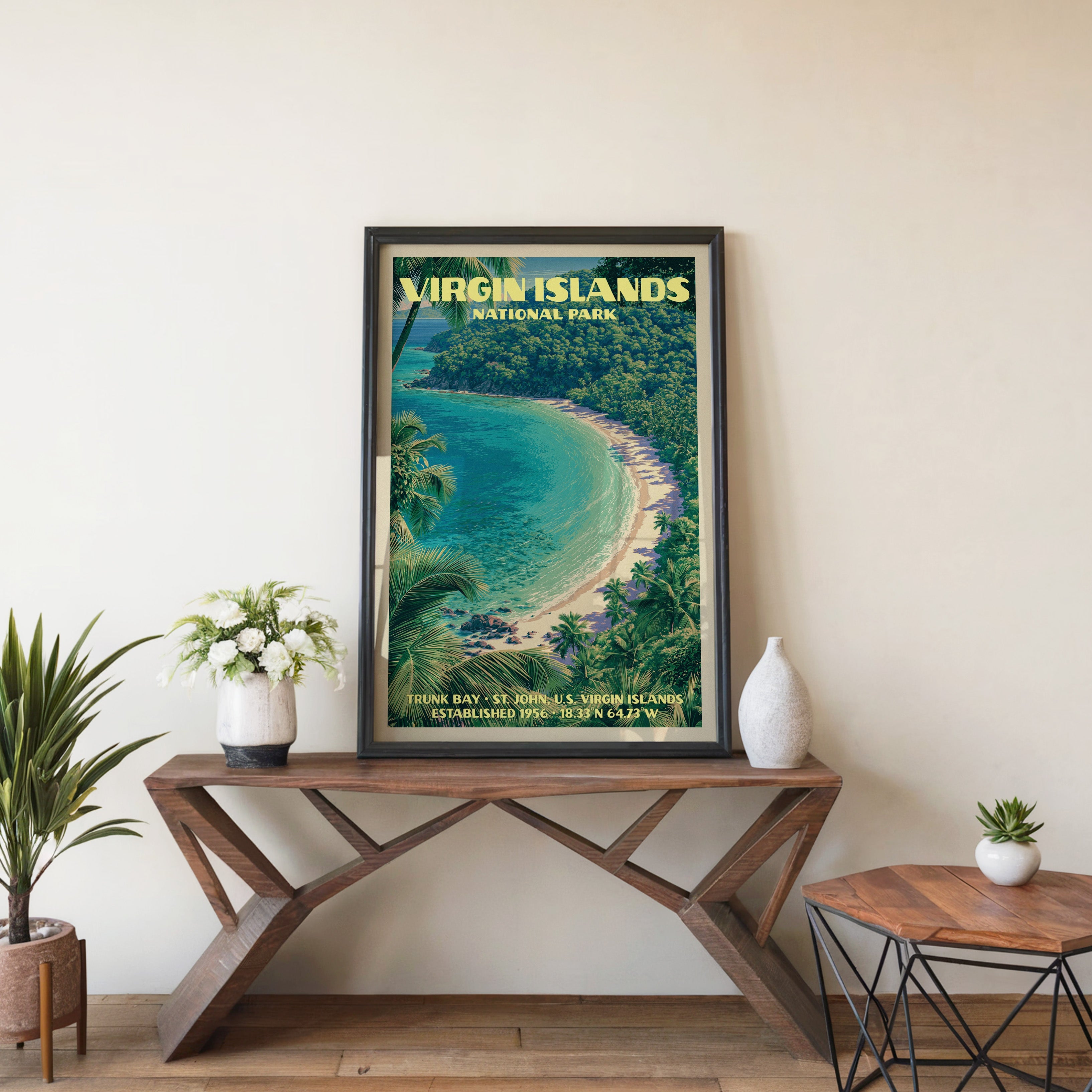 Trunk Bay wall art in black, leaning on a walnut console with white anemones and a small white vase