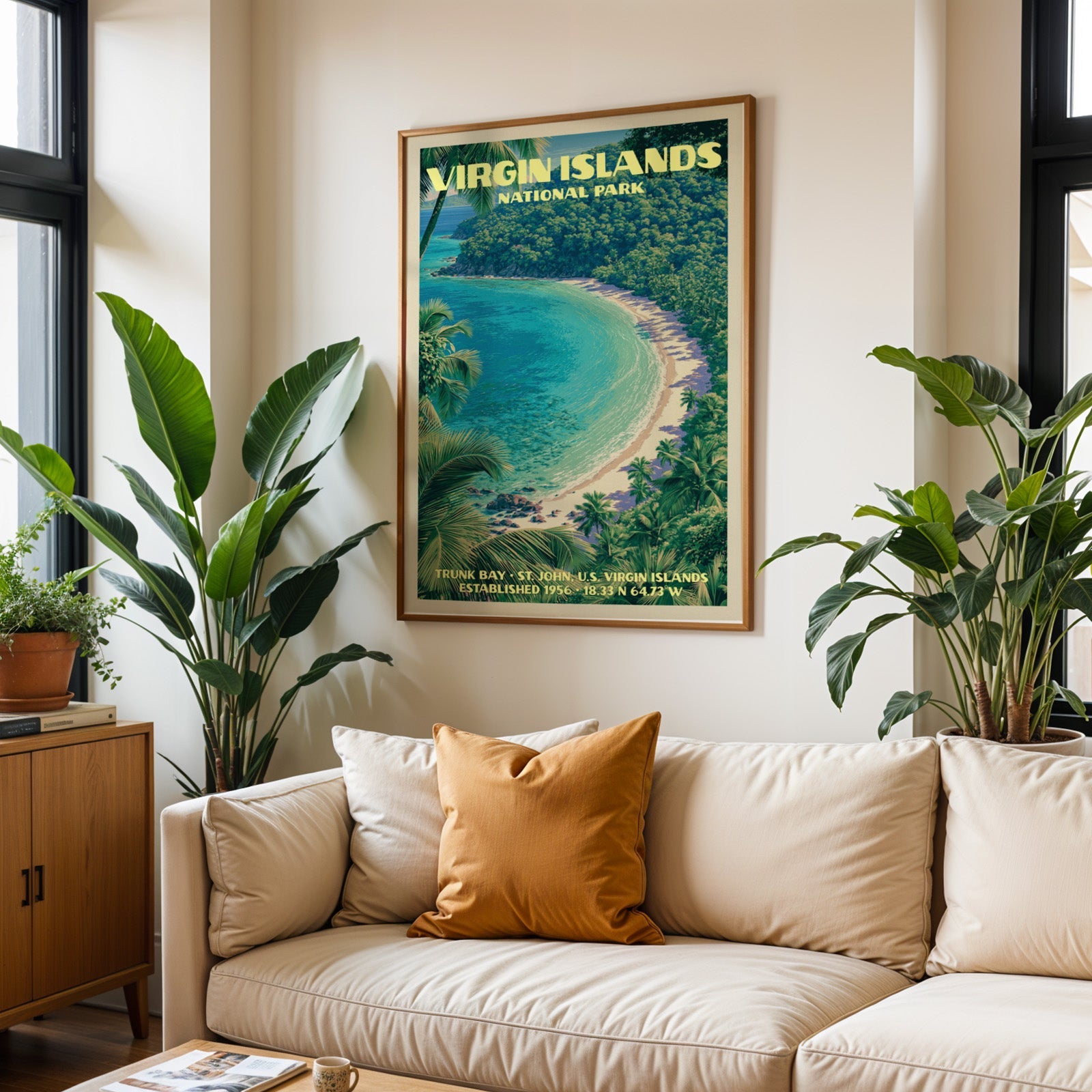 Virgin Islands vintage travel print in oak above a cream sofa with a rust cushion and tall houseplants