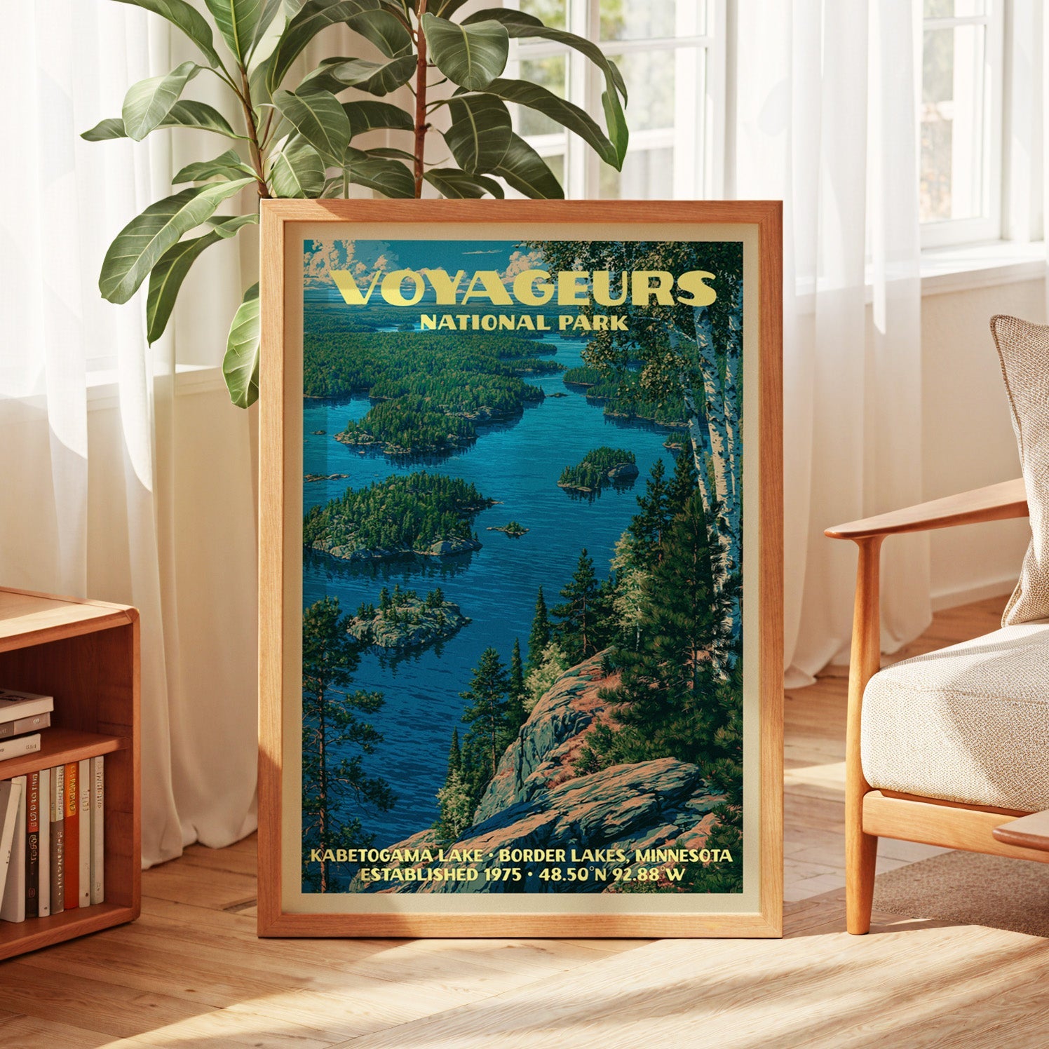 Voyageurs north woods print in oak, leaning by a sunlit window with sheer curtains and a low bookshelf