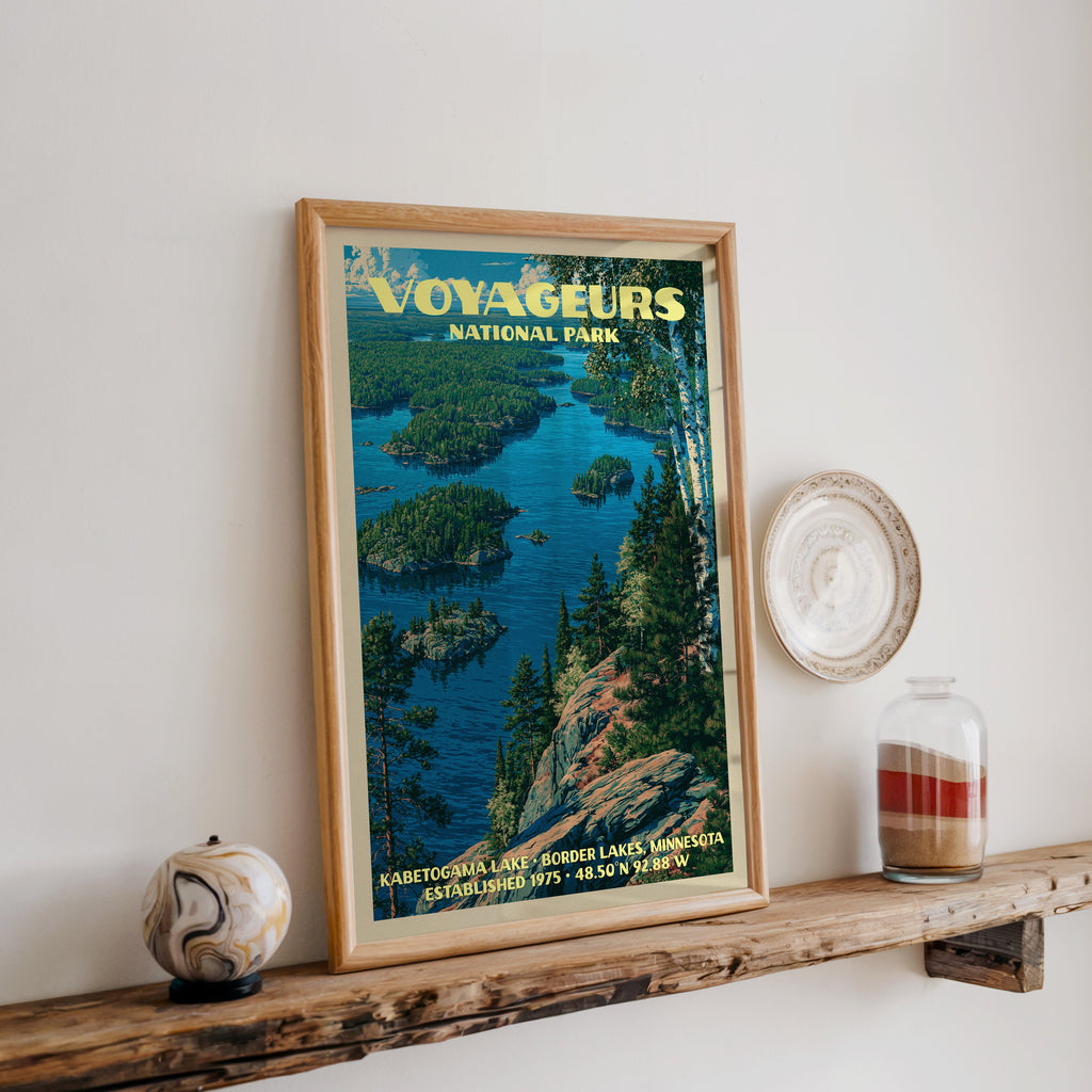 Voyageurs Kabetogama Lake print in oak, leaning on a reclaimed wood ledge with a stone sphere and sand jar