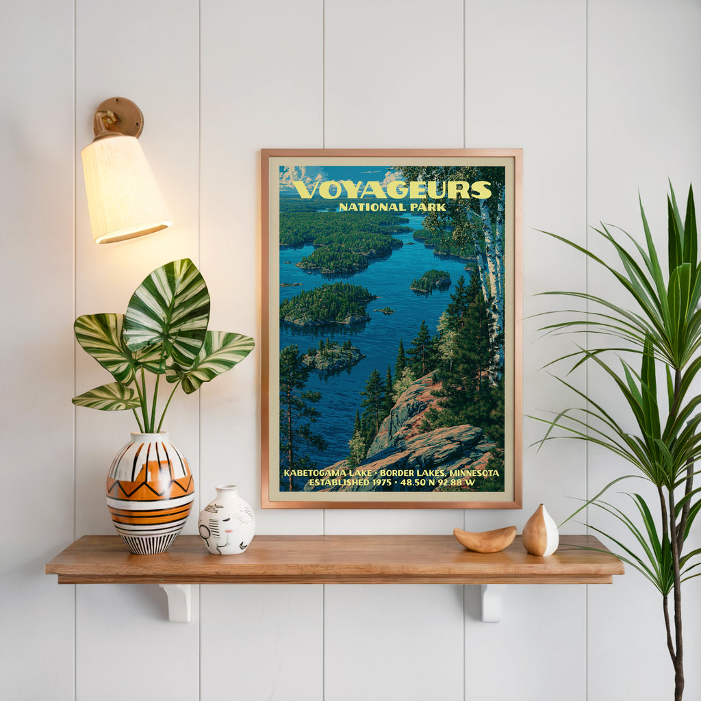 Kabetogama Lake print framed on white panelling above an oak shelf with a patterned vase and a sconce