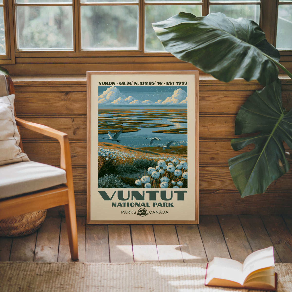 Vuntut National Park canvas print in an oak frame against a pine cabin wall beside a monstera