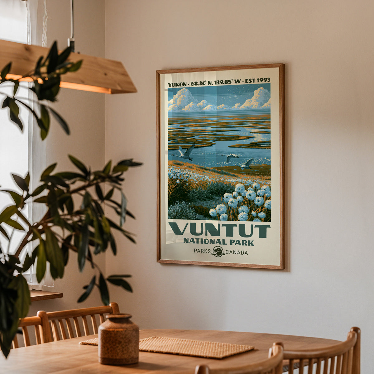 Vuntut National Park poster with flying swans in an oak frame in a dining corner above an oak table