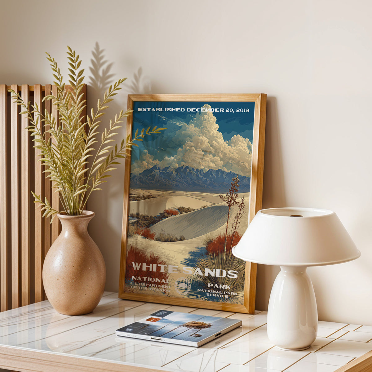 White Sands National Park vintage print leaning on a table with a ceramic lamp and dried grasses