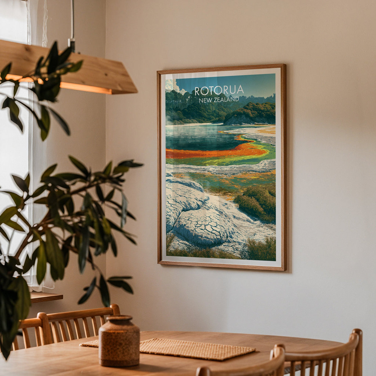 Framed Wai-O-Tapu print in a dining corner with an oak table, spindle chairs and wood pendant light