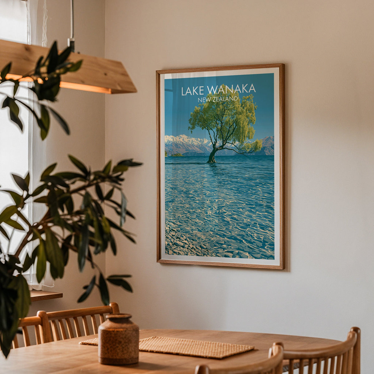 Otago lake poster in a dining corner with an oak table, spindle chairs and a wood pendant light