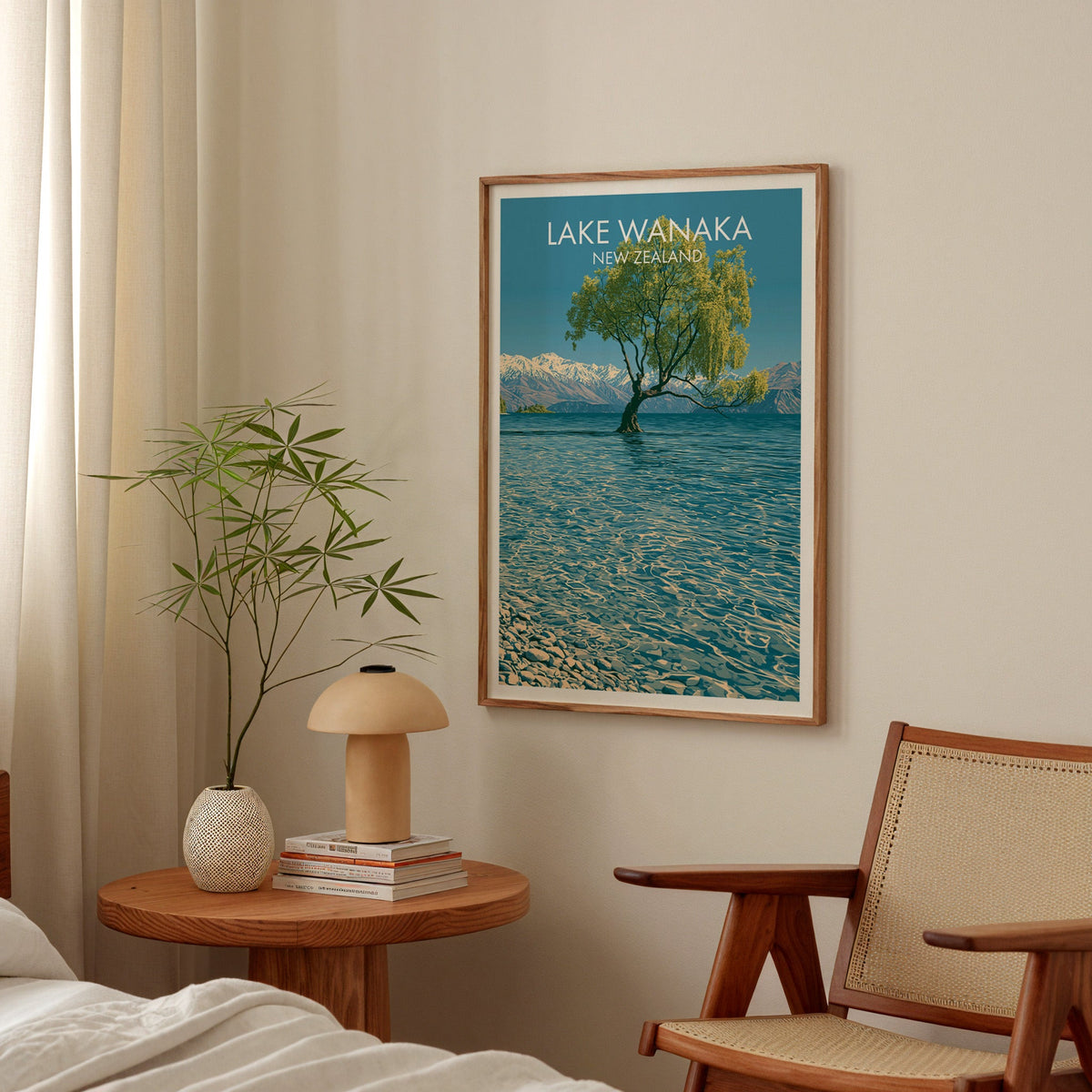 Willow and alpine lake artwork in a bedroom above a round bedside table with a mushroom lamp