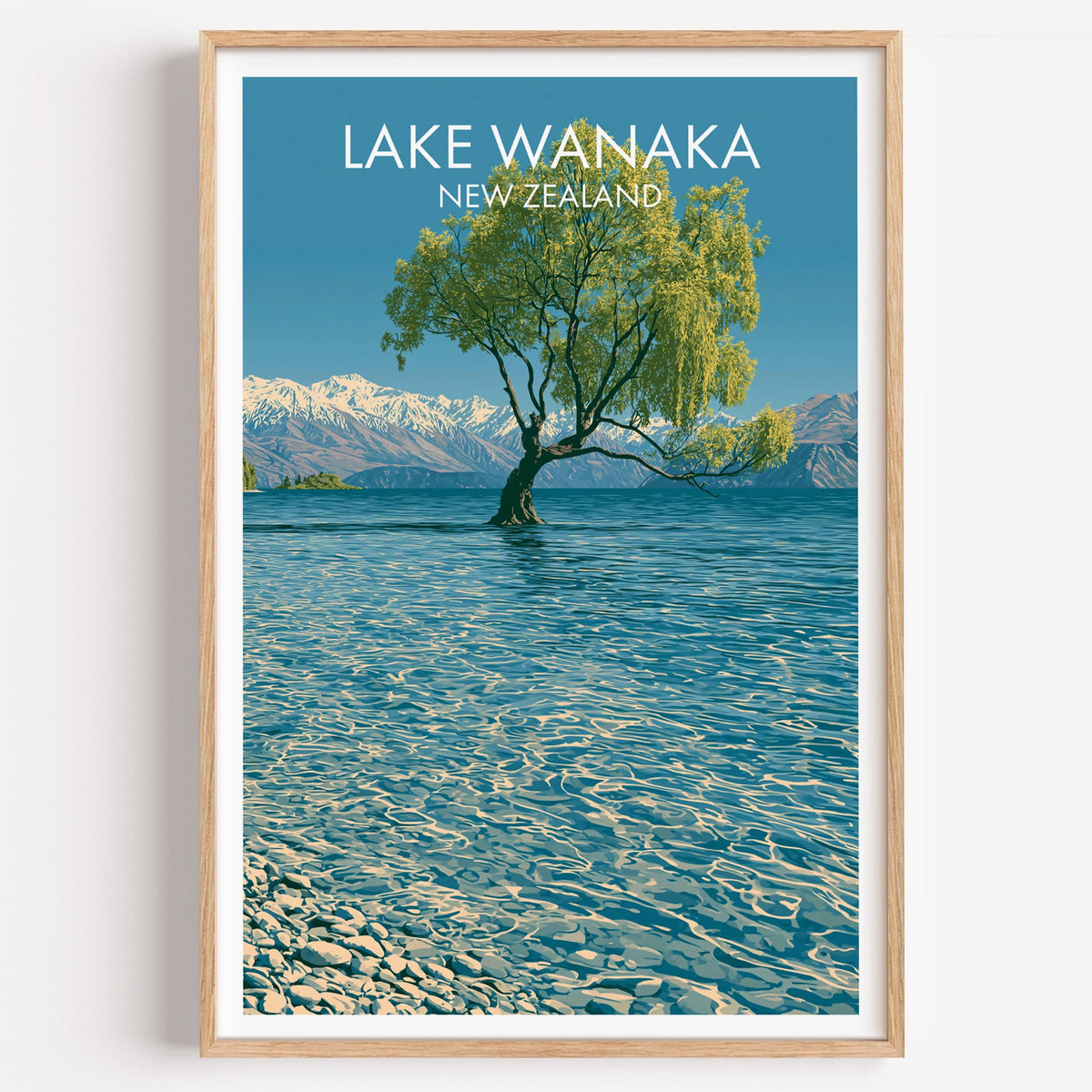 Lake Wanaka willow tree print in a light oak frame on a plain white wall