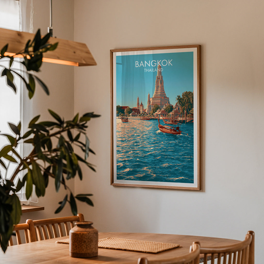 Framed Wat Arun Bangkok Thailand print on a dining room wall above an oak table in warm afternoon light