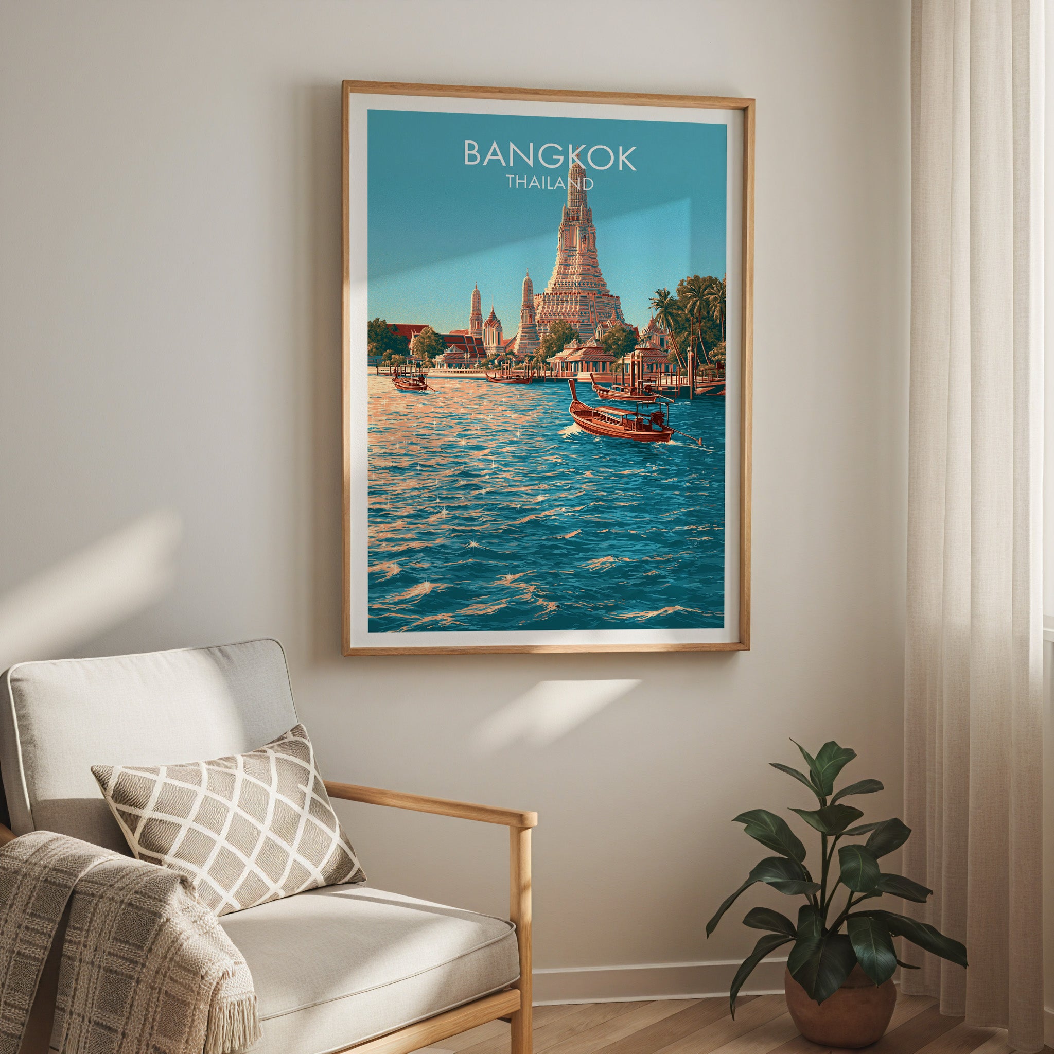Wat Arun Bangkok Thailand travel print in a light oak frame on a living room wall beside a linen armchair