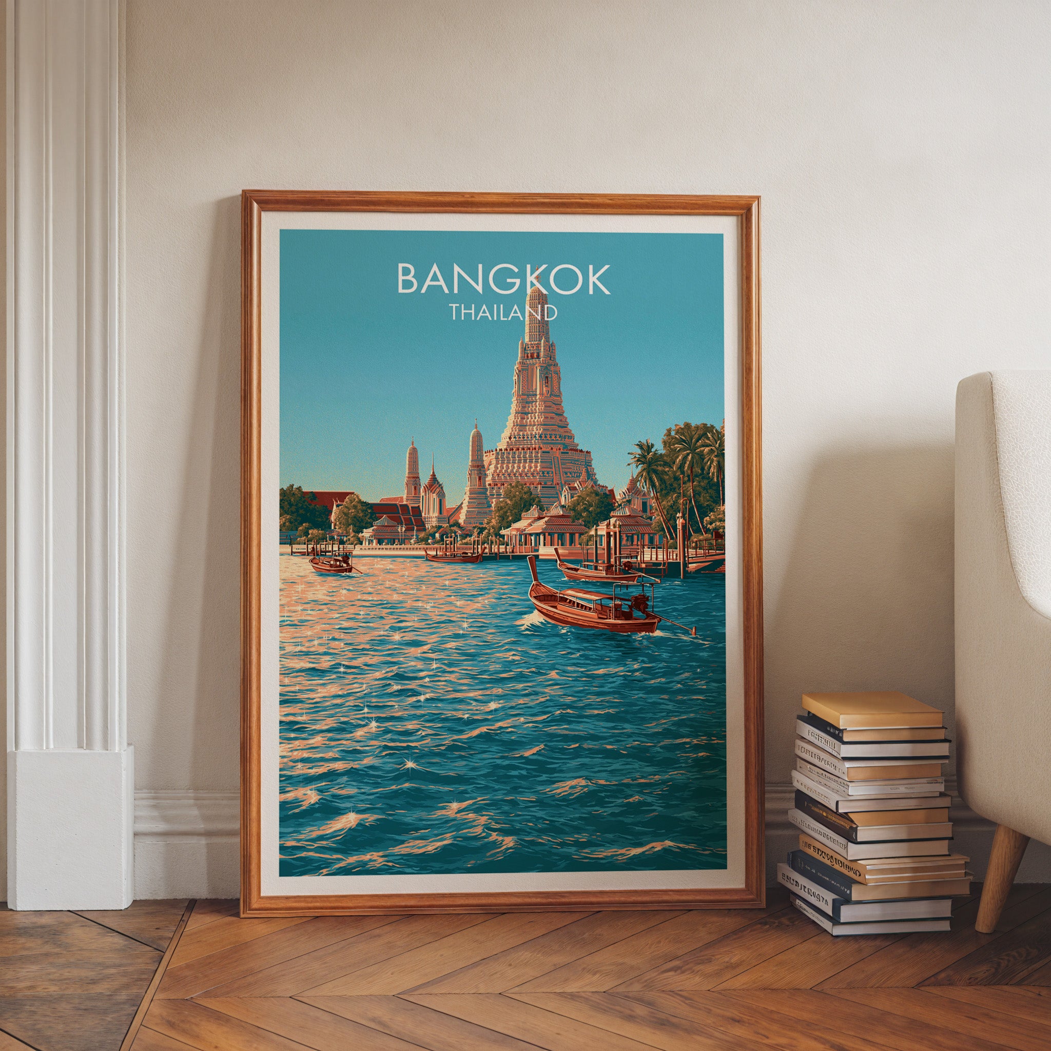 Wat Arun Bangkok Thailand art print in a walnut frame leaning in a hallway beside stacked books