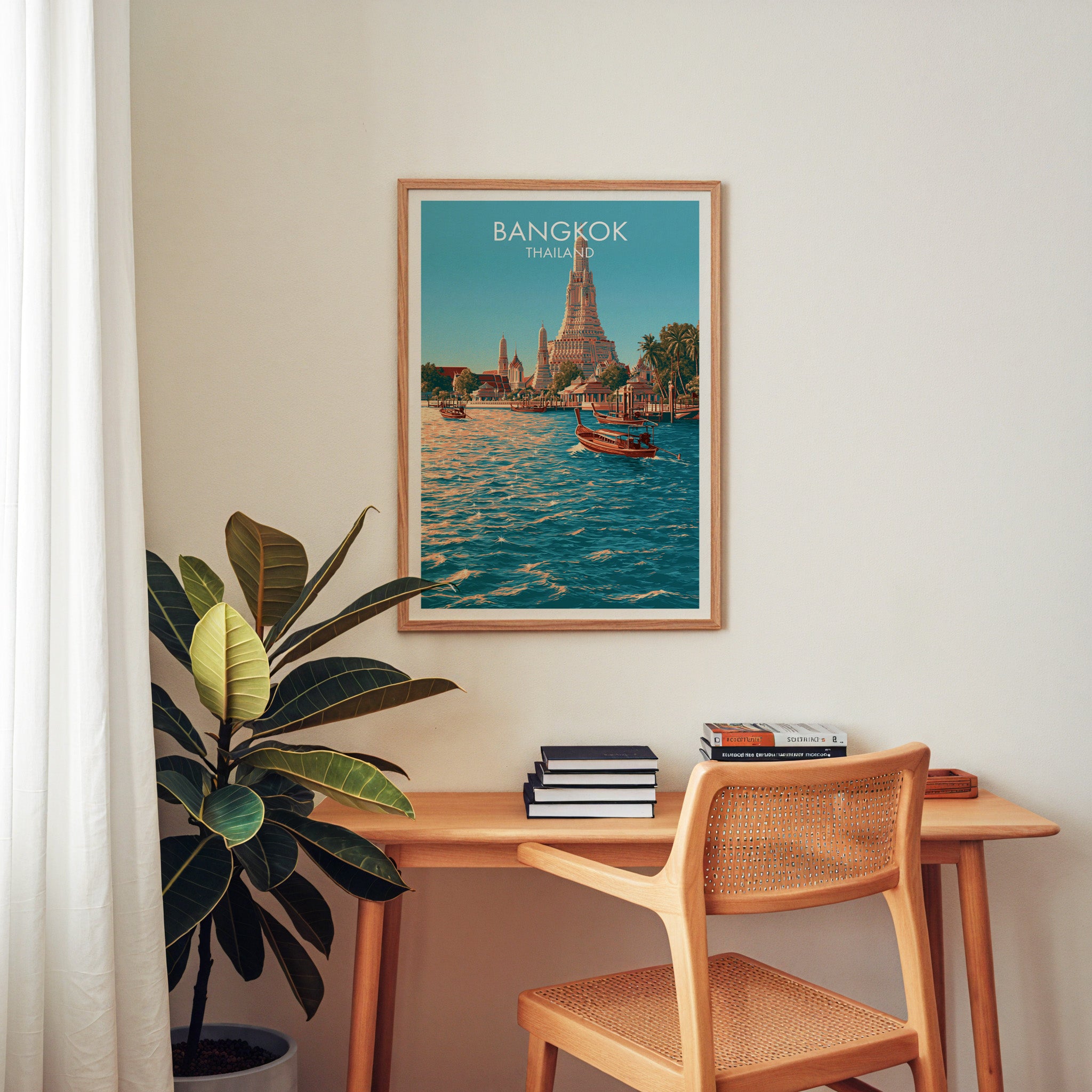 Wat Arun Bangkok Thailand wall art above a wooden home office desk with a rattan chair and books
