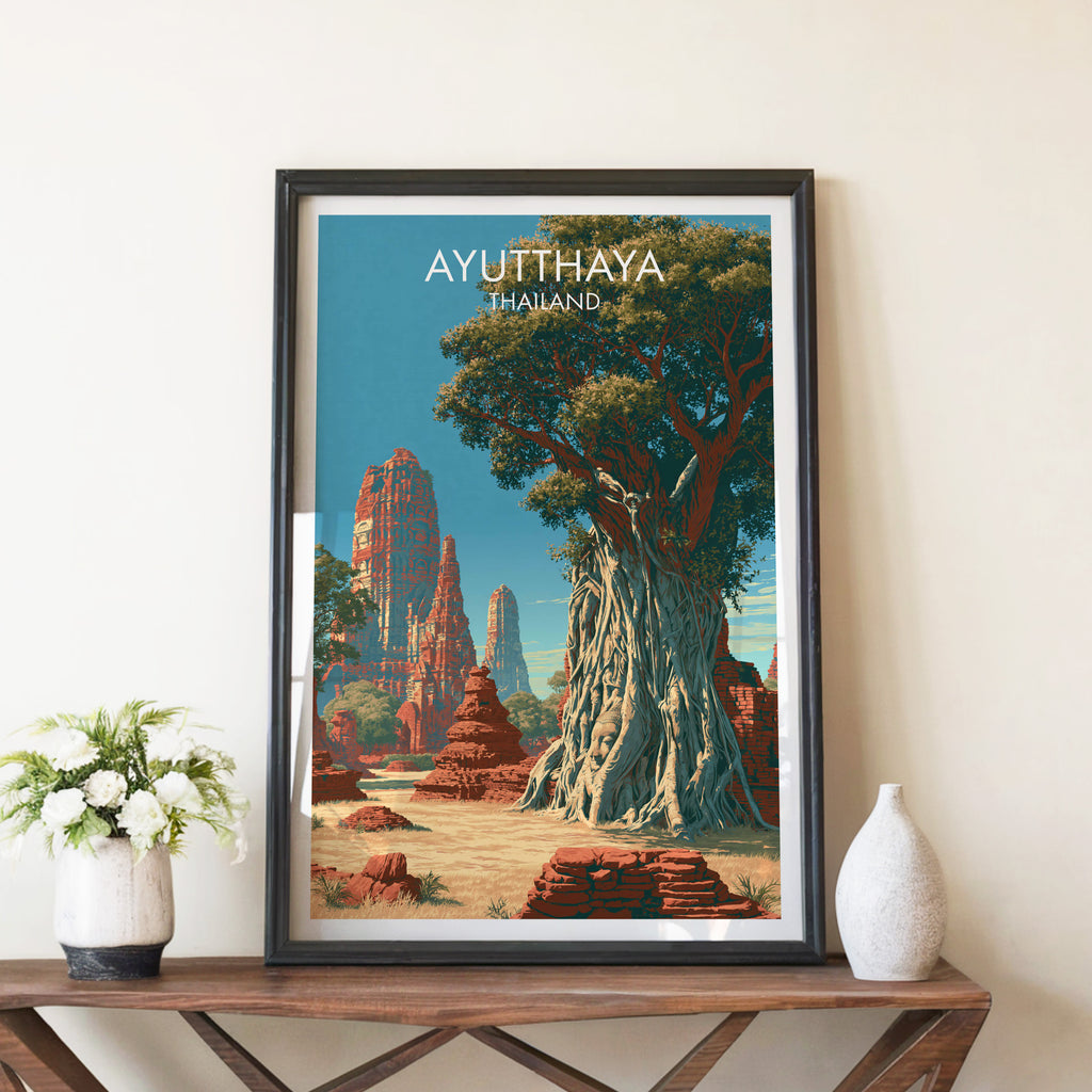 Wat Mahathat Ayutthaya Thailand travel poster in a black frame on a wooden console table with white flowers