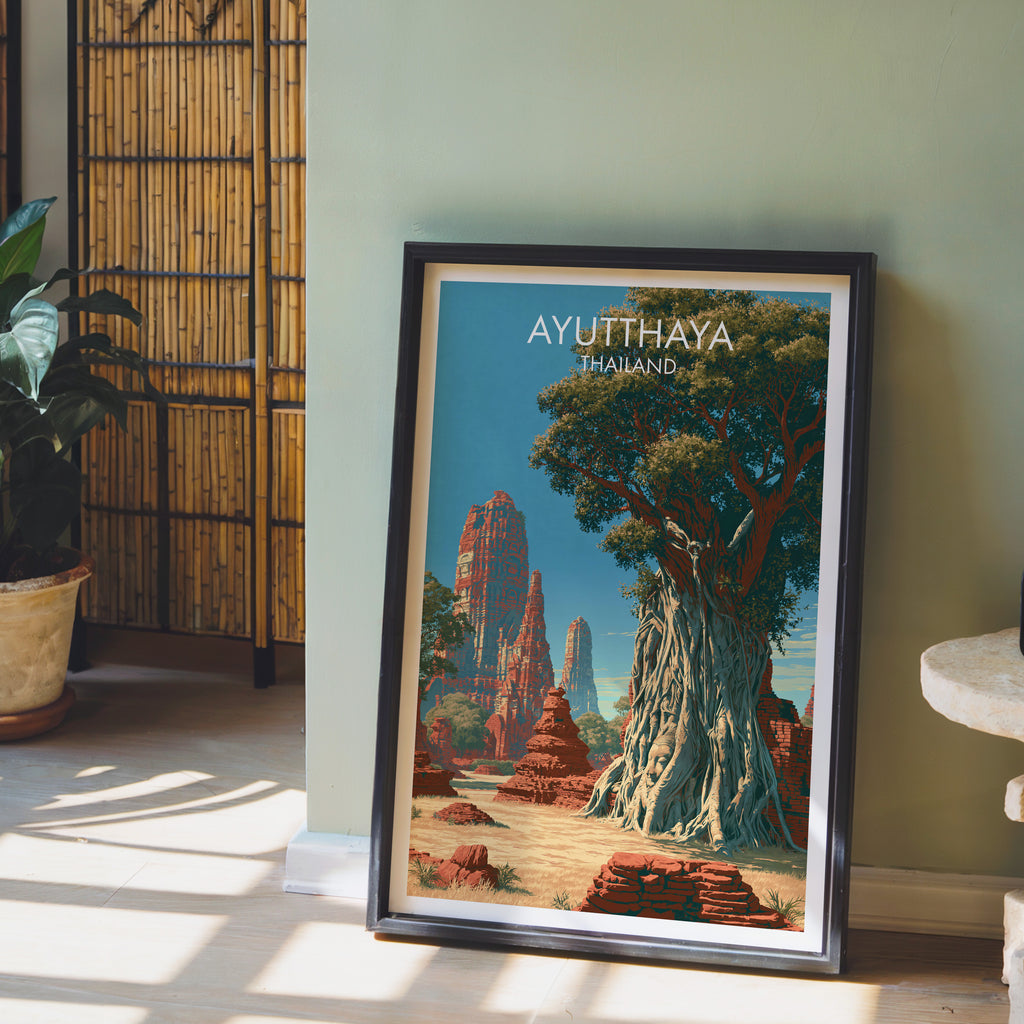 Wat Mahathat Ayutthaya Thailand wall art in a black frame leaning against a sage green wall beside a bamboo screen