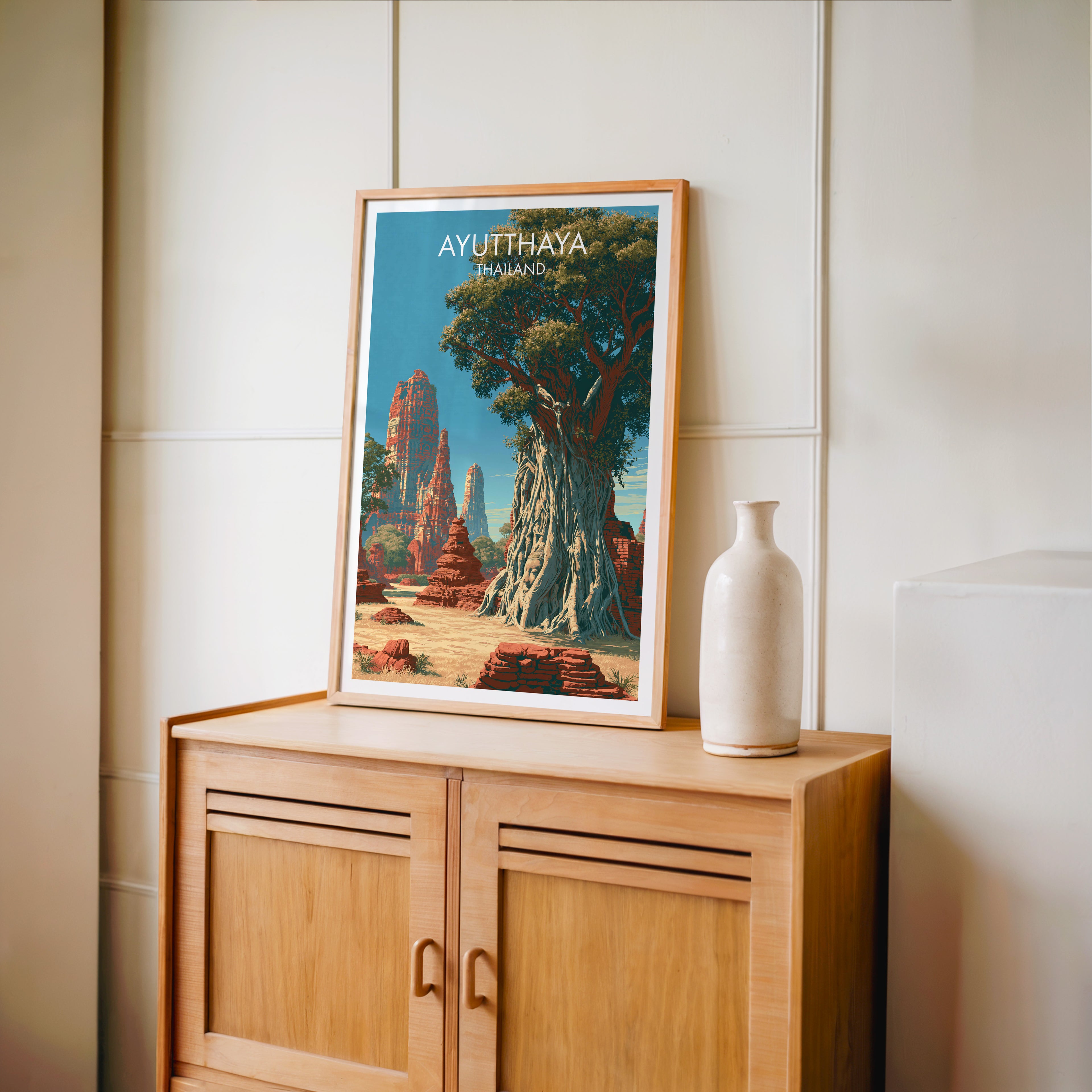 Small Wat Mahathat Ayutthaya Thailand travel poster in an oak frame on a mid-century sideboard with a ceramic vase