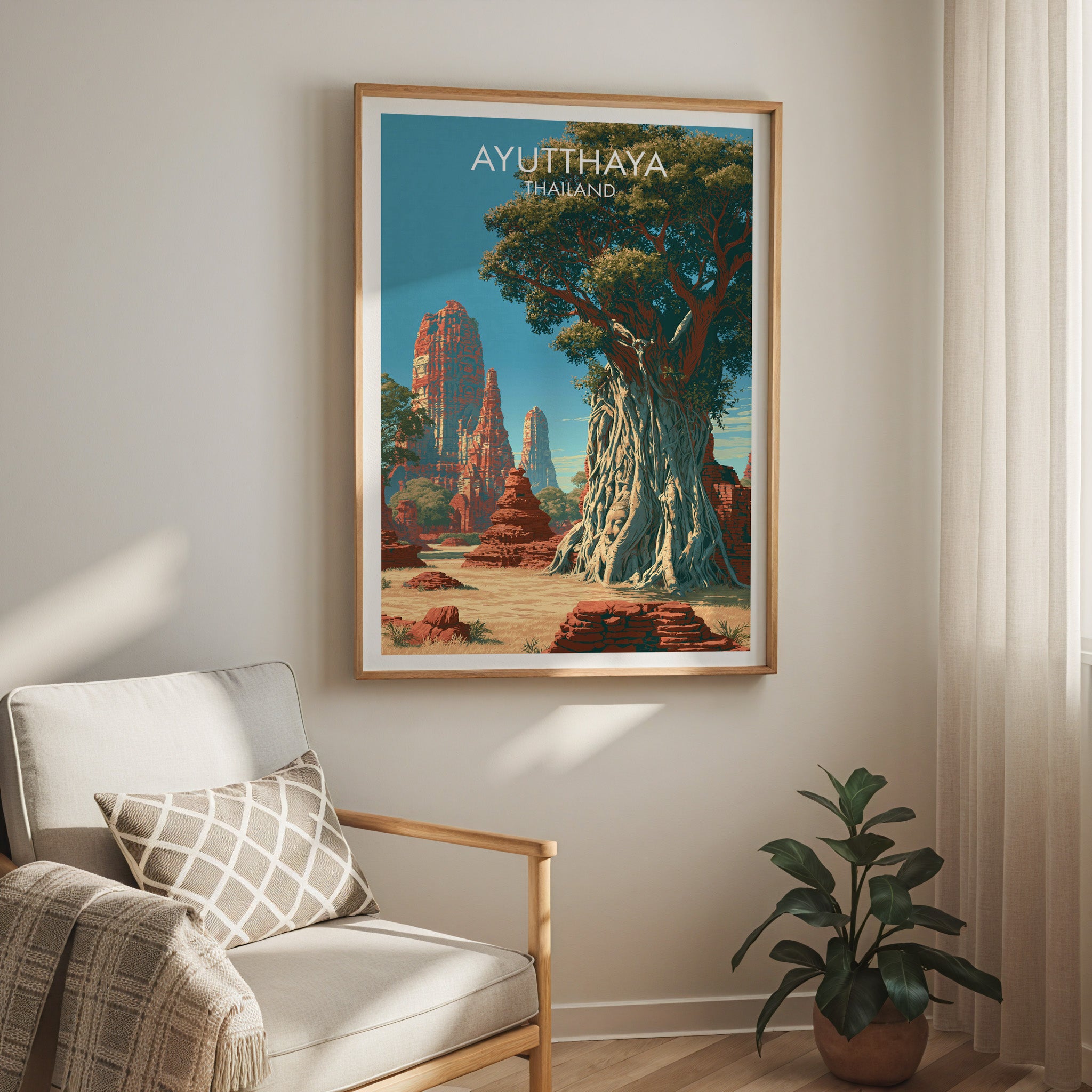 Wat Mahathat Ayutthaya Thailand travel print in a light oak frame on a living room wall beside a linen armchair