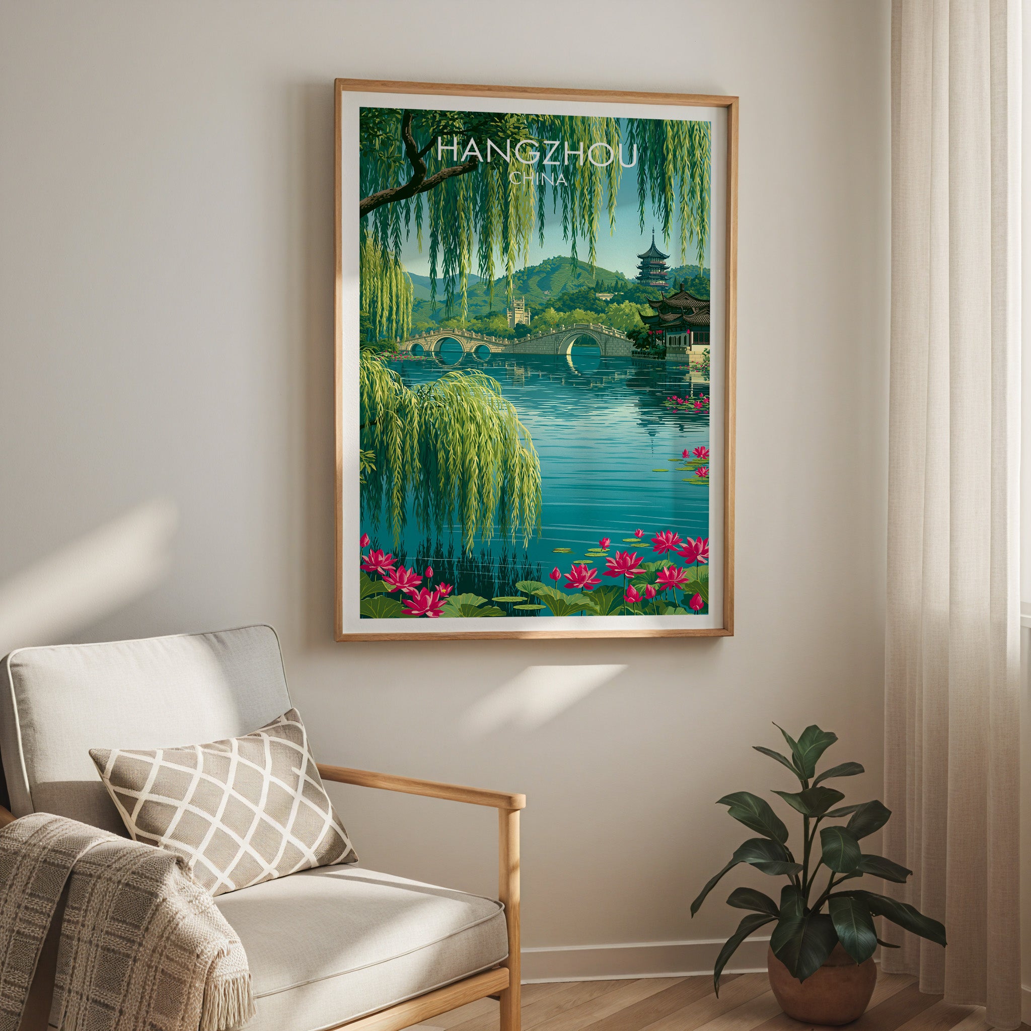 West Lake Hangzhou China travel print in a light oak frame on a living room wall beside a linen armchair