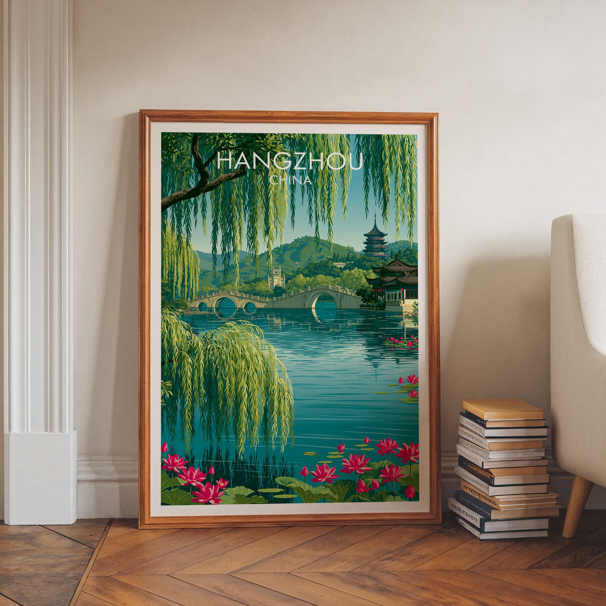 West Lake Hangzhou China art print in a walnut frame leaning in a hallway beside stacked books
