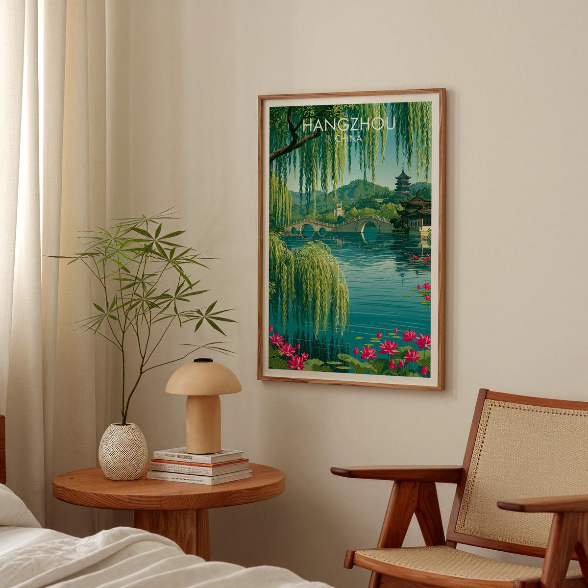 West Lake Hangzhou travel poster in an oak frame above a round bedside table with a mushroom lamp and bamboo stems
