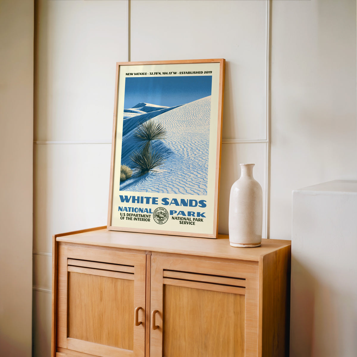 White Sands National Park WPA print framed in light oak on a wooden sideboard with a ceramic vase