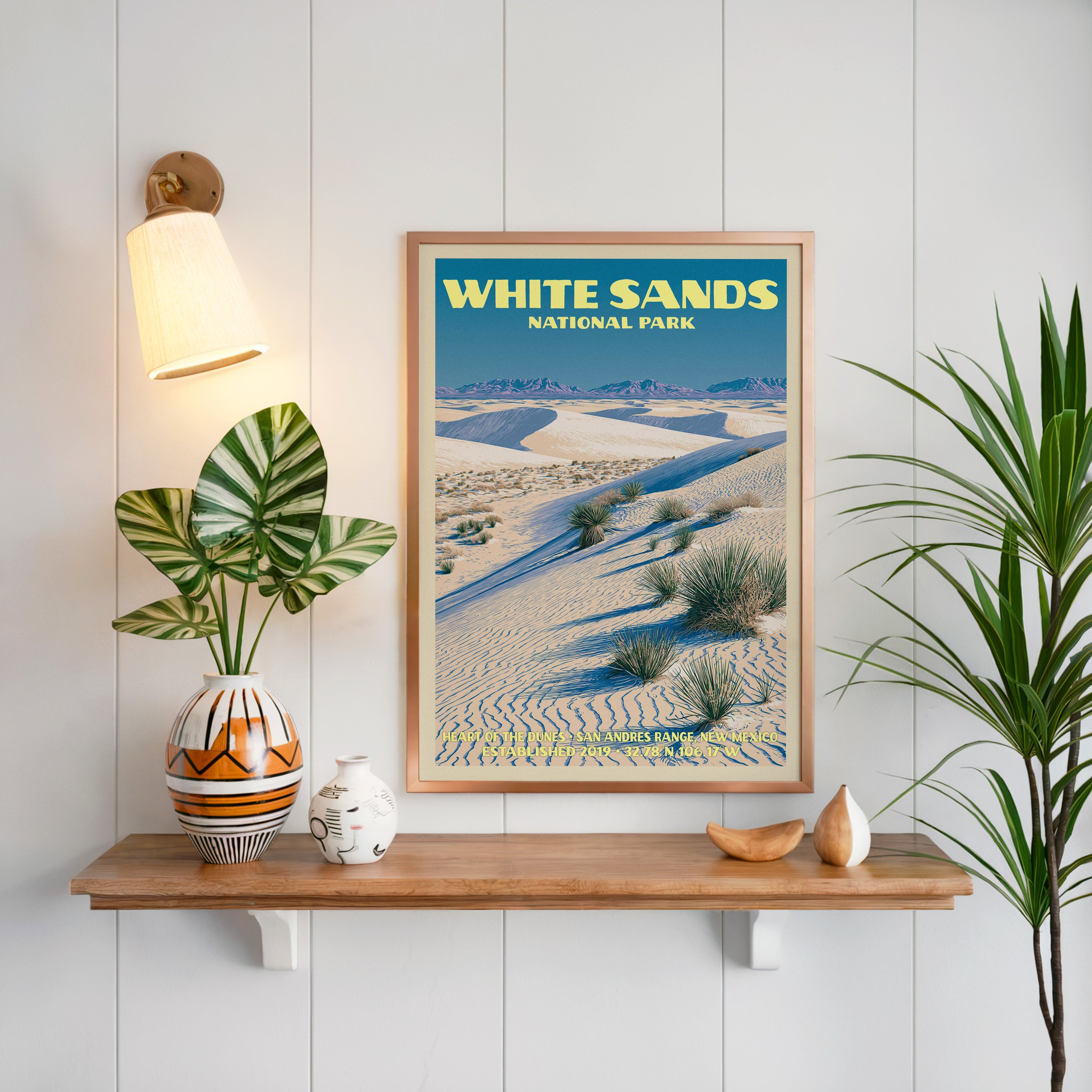 Heart of the Dunes print framed in oak on white panelling above a floating shelf with a patterned vase