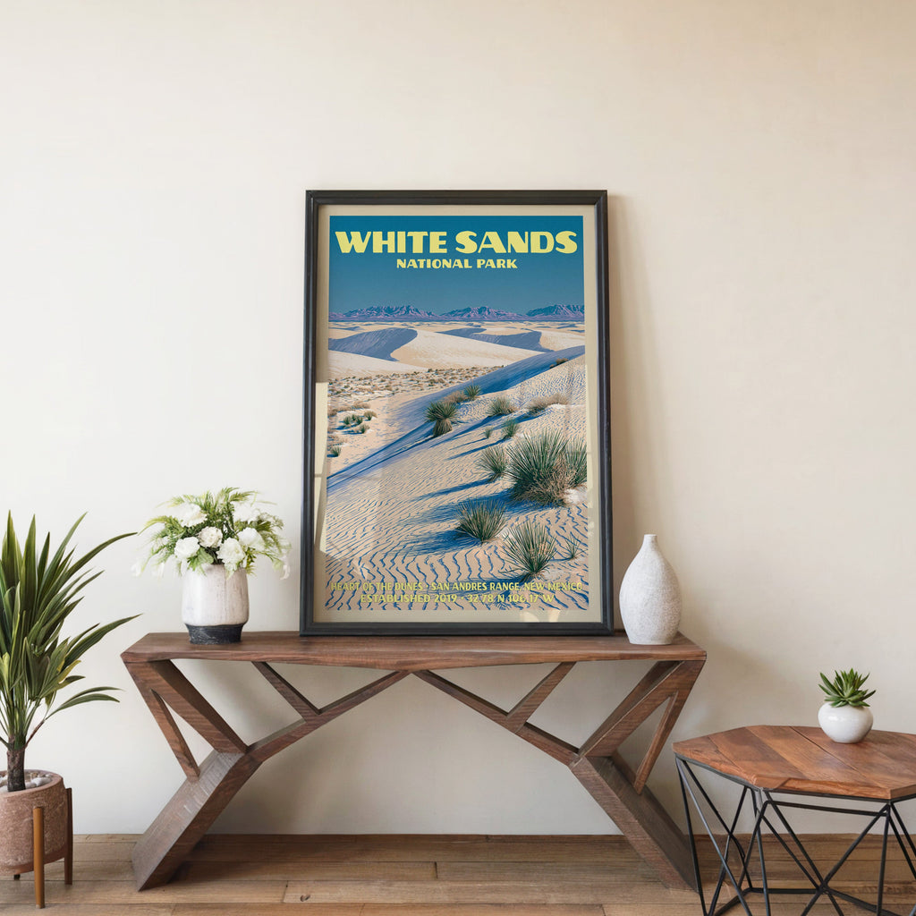 Heart of the Dunes wall art in black, leaning on a walnut console with white anemones and a ceramic vase