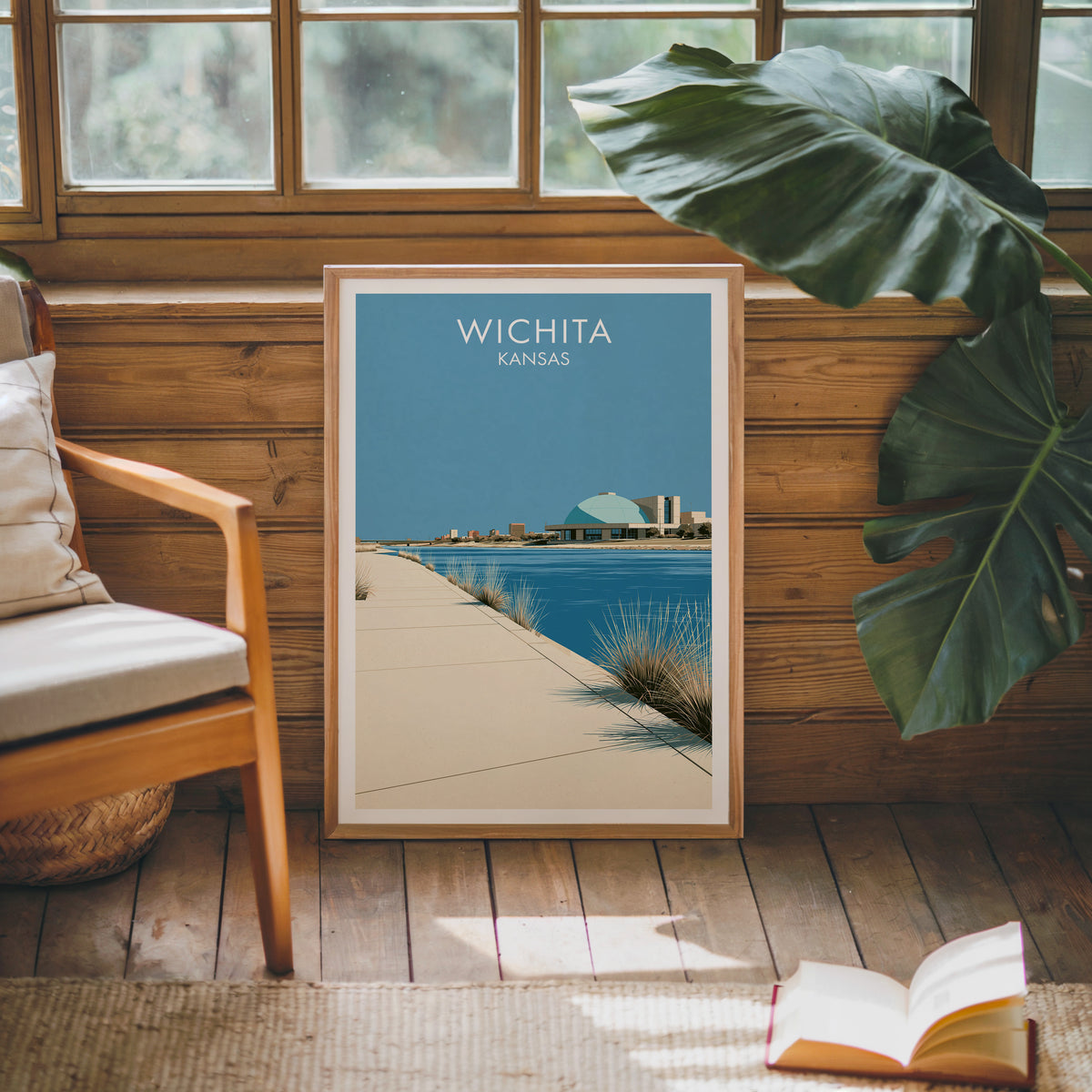 Teal dome riverfront print in oak on a sunlit wood-grain wall by a mid-century armchair and open book.