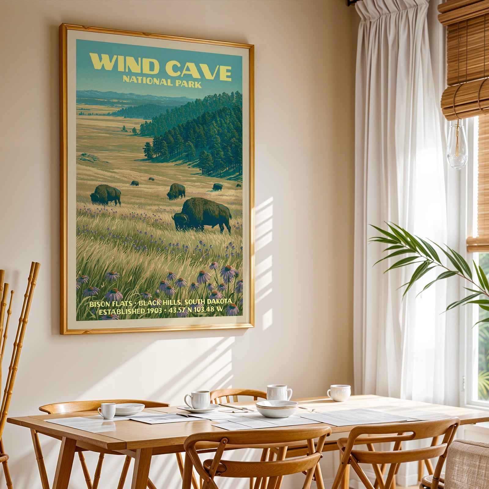 Wind Cave National Park print in gold above a light oak dining table by a sheer-curtained window