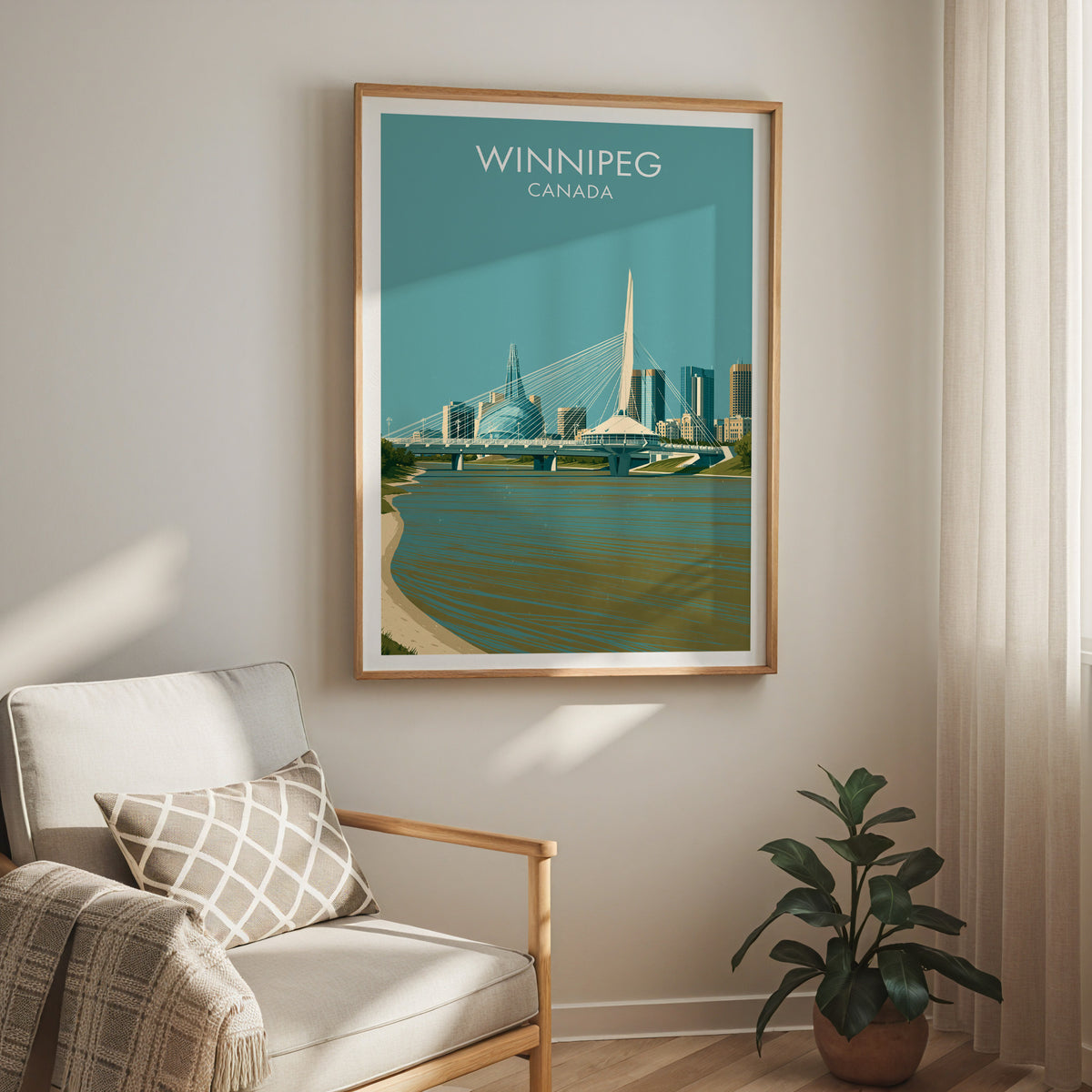 Winnipeg Red River bridge print in an oak frame above a cream armchair and a rubber plant