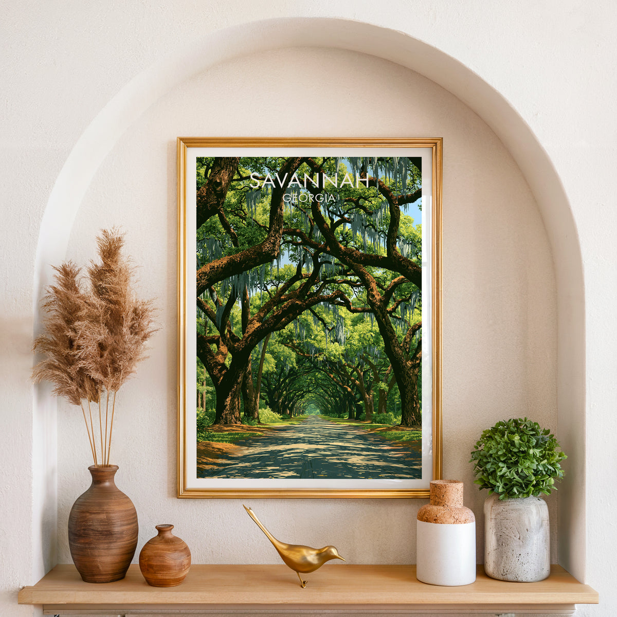 Gold frame in an arched wall niche with pampas grass and a brass bird, coastal Georgia live oak print.