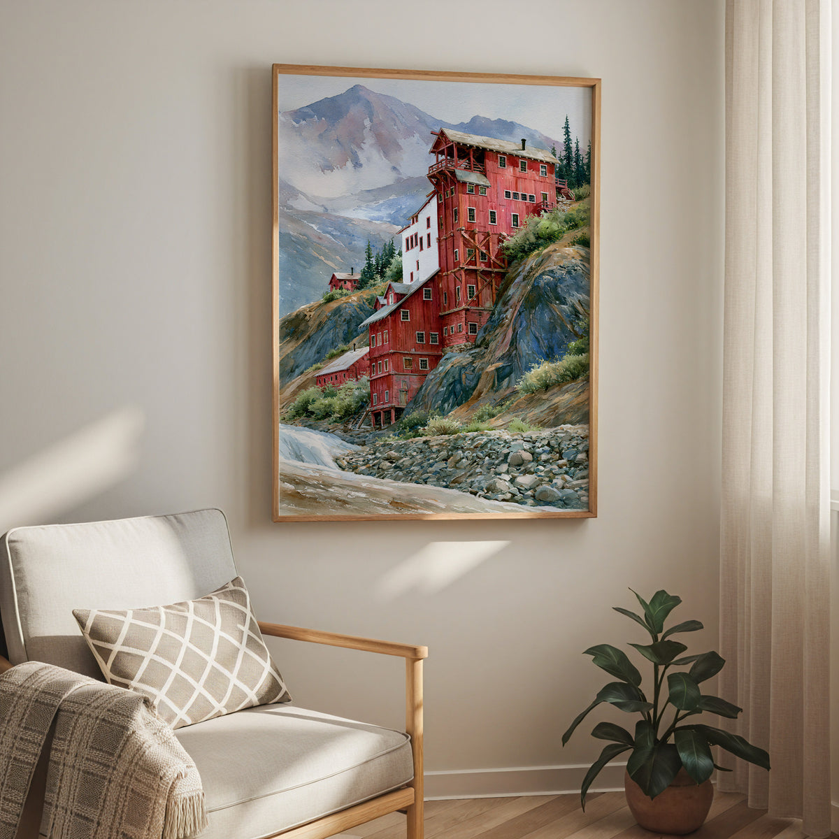 Oak-framed Wrangell-St. Elias watercolor print hung above a cream armchair in a bright living room
