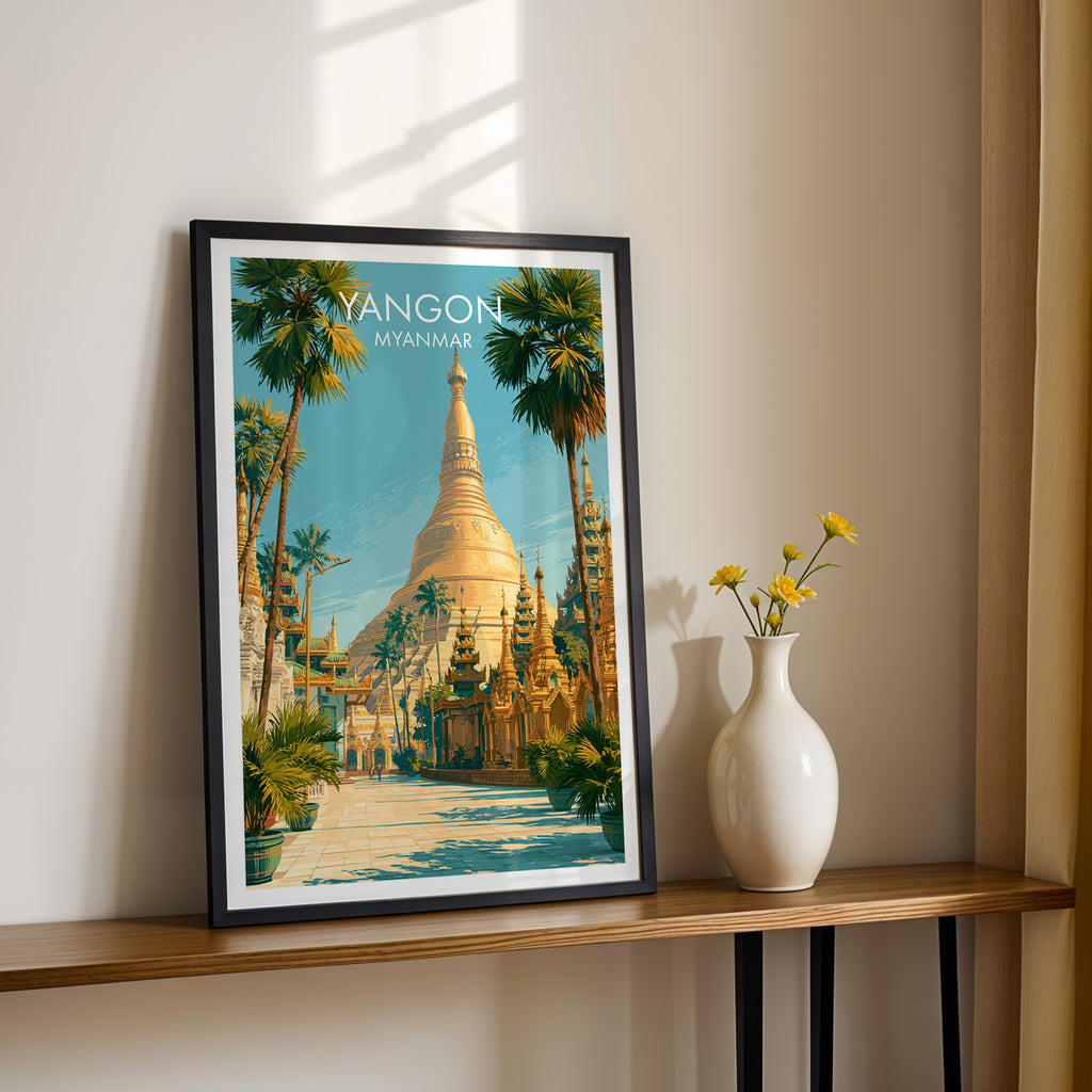 Black framed Yangon Myanmar print on a narrow hallway console in sunlight, styled with yellow flowers