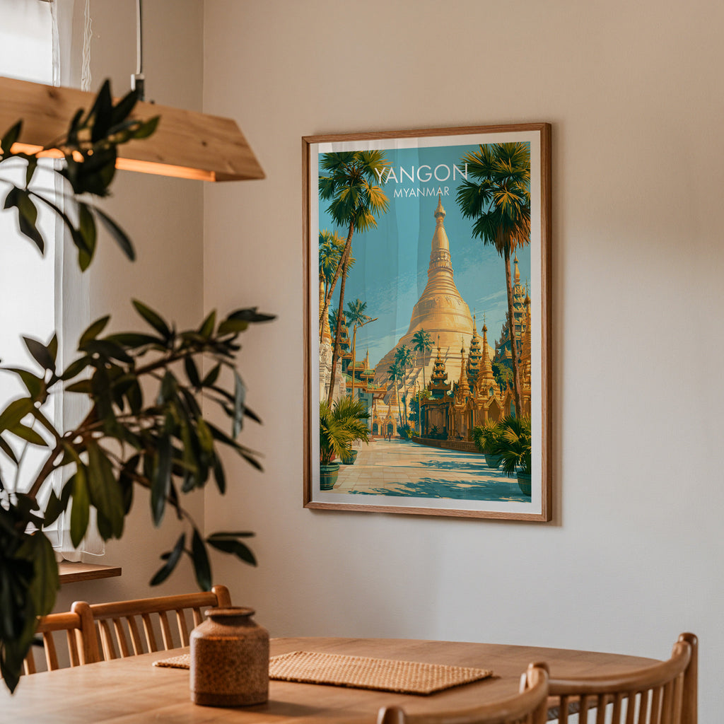 Framed Yangon Myanmar print on a dining room wall above an oak table in warm afternoon light