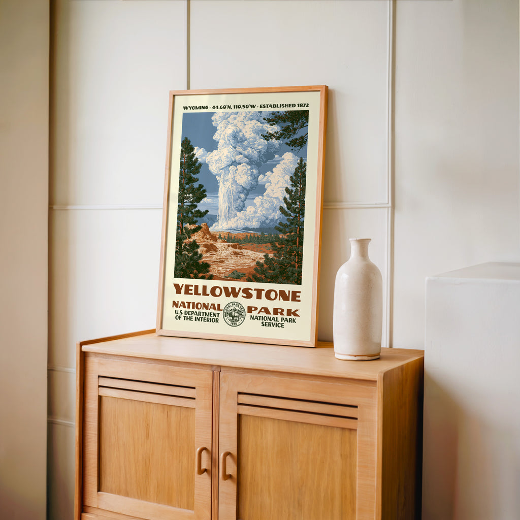 Yellowstone National Park WPA print framed in light oak on a wooden sideboard with a ceramic vase