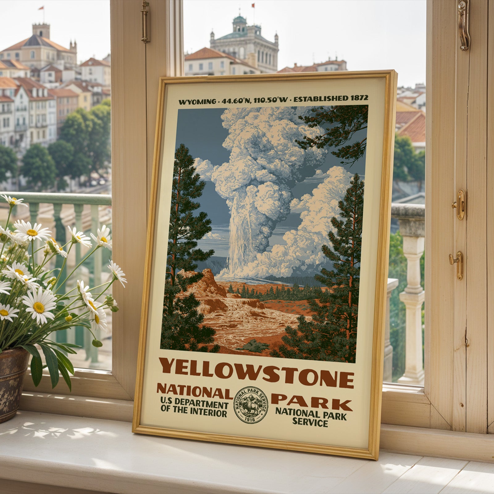 Yellowstone National Park poster framed on a sunlit windowsill with fresh daisies and a bright view