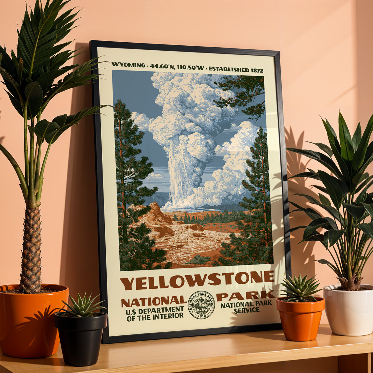 Yellowstone National Park WPA print in a black frame on a shelf against a warm terracotta wall